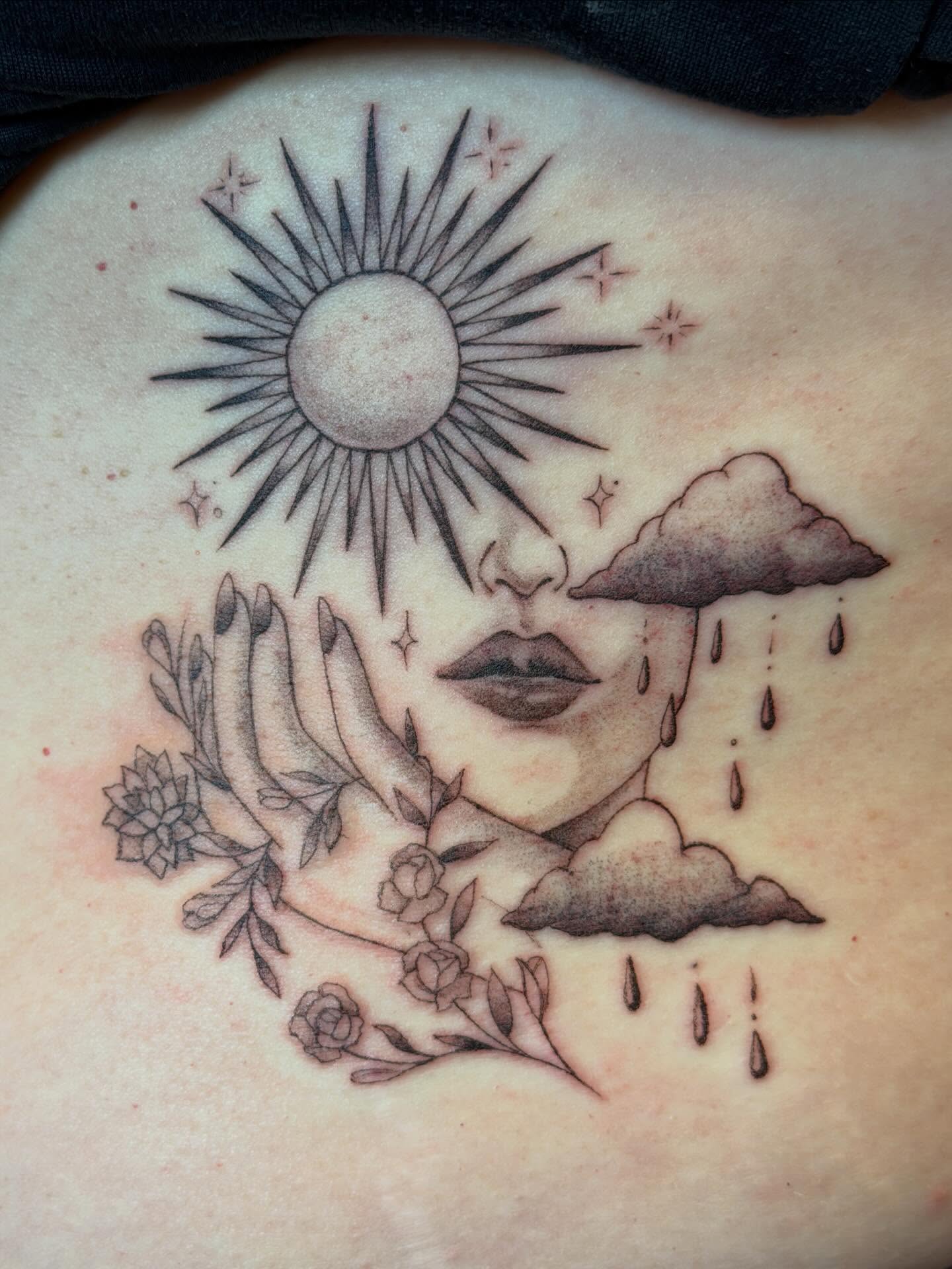 Sun, cloud, lips, flowers realism tattoo on the torso by Raul Najera Tattoo, Plano, Texas