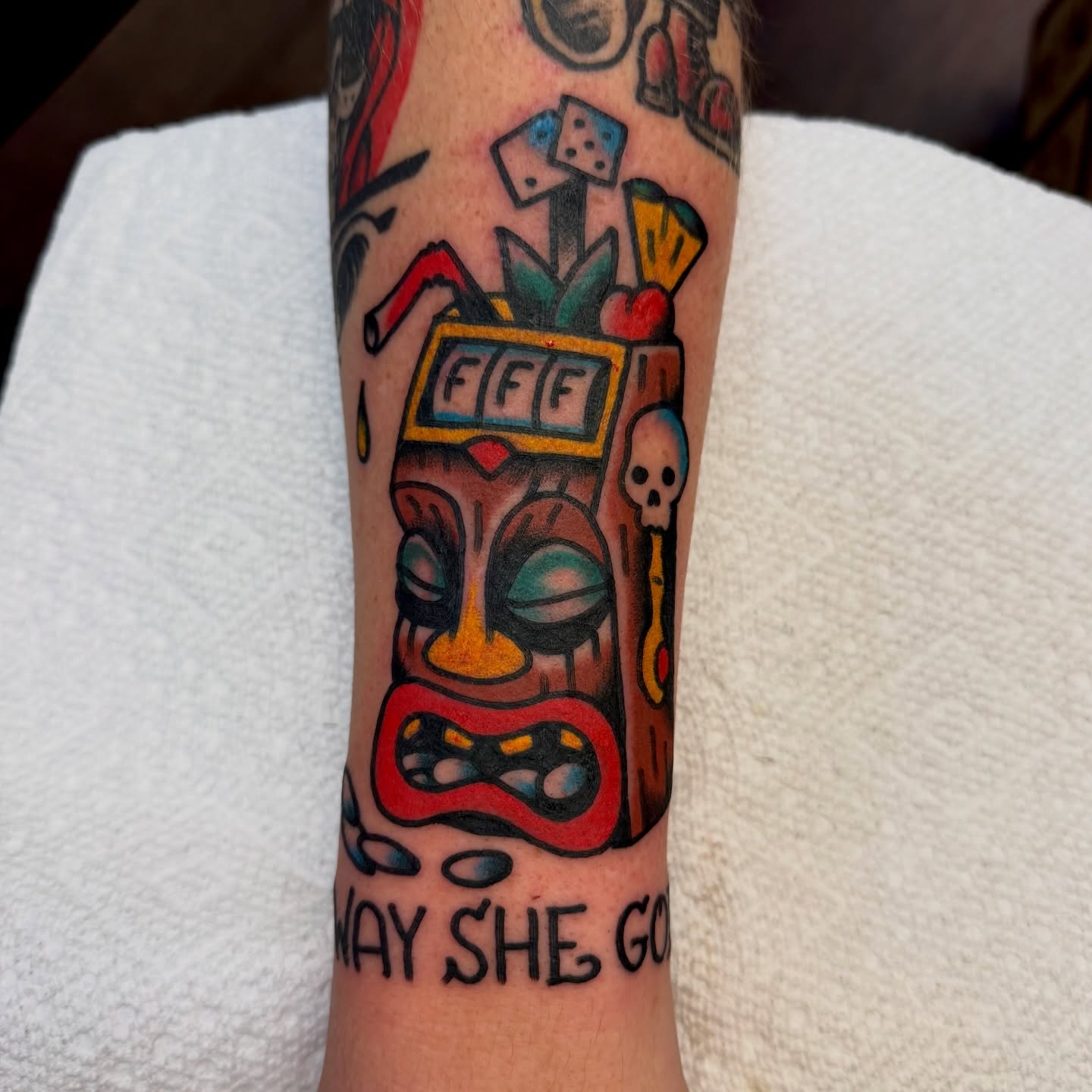 Slot machine tiki mask American traditional tattoo on the forearm by Buddy (Holiday) Orr, Las Vegas, Nevada