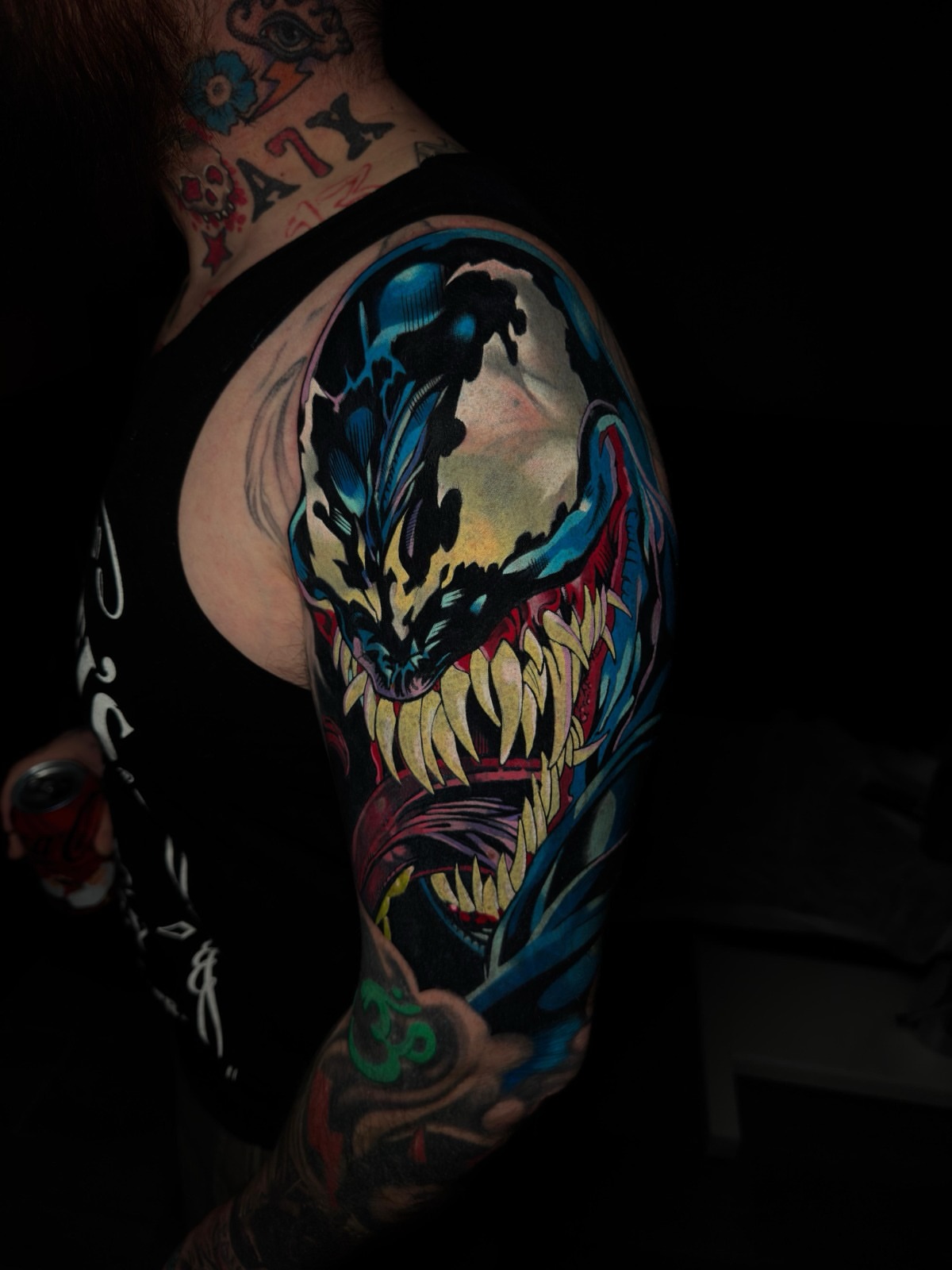 Venom realism tattoo on the upper arm by Cristian Romero