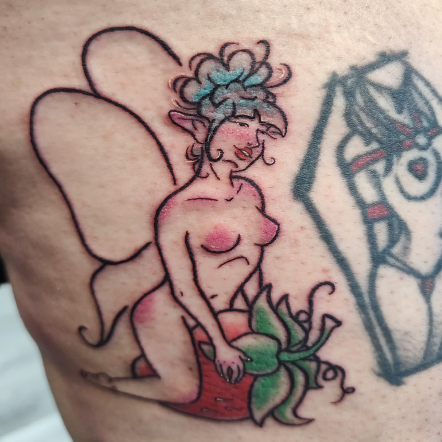Fairy on strawberry American traditional tattoo on the thigh by Mercury