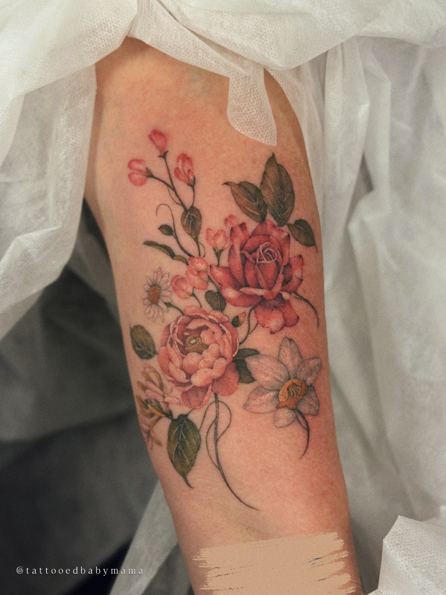 Floral bouquet realism tattoo on the forearm by Andrea Evangelista
