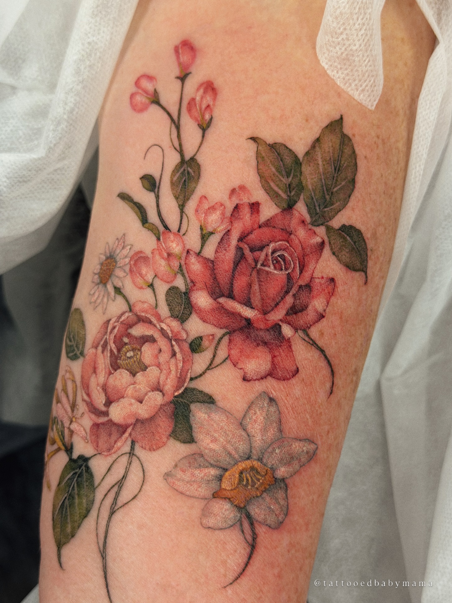 Floral bouquet realism tattoo on the forearm by Andrea Evangelista
