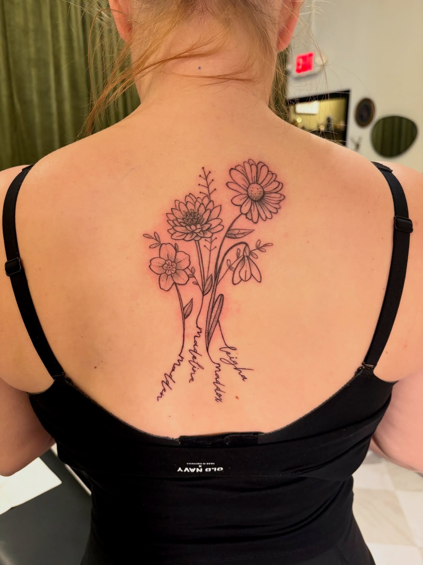 Flowers black and grey tattoo on the back by Emily, Monticello, Iowa