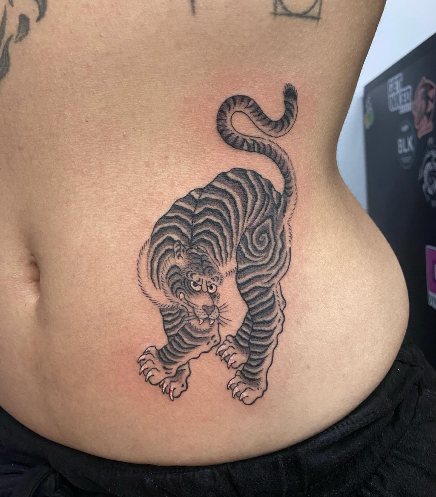 Tiger black and grey tattoo on the torso by Lucas Naganuma