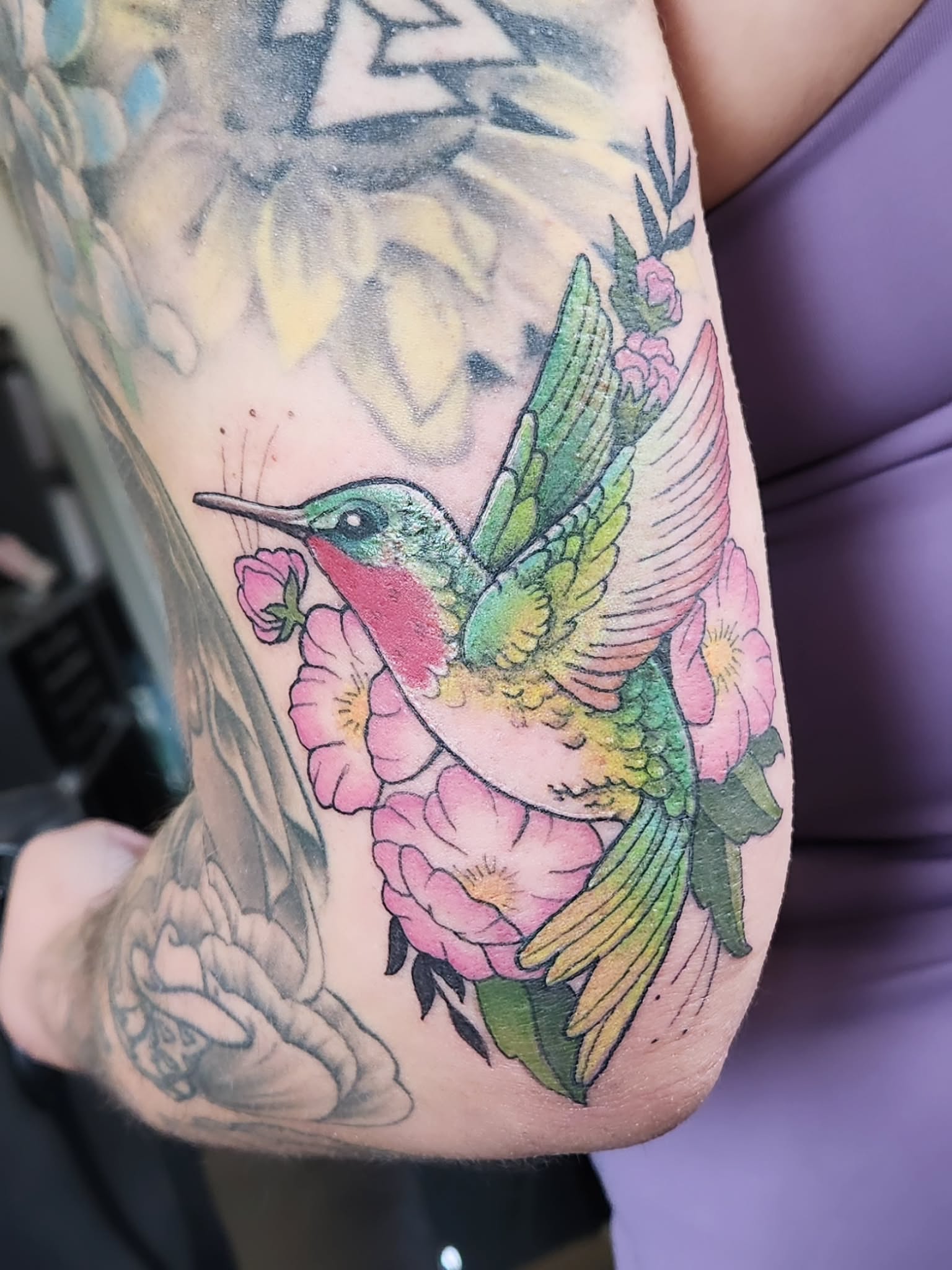 Hummingbird and flowers new school tattoo on the forearm by Amanda Boyd - Duh!