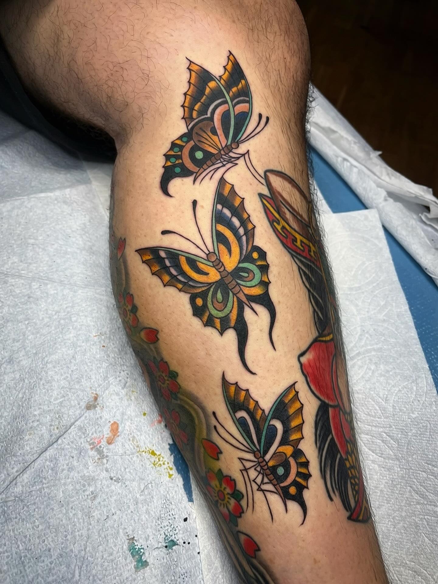 Butterflies and flowers American traditional tattoo on the forearm by Graham Niles