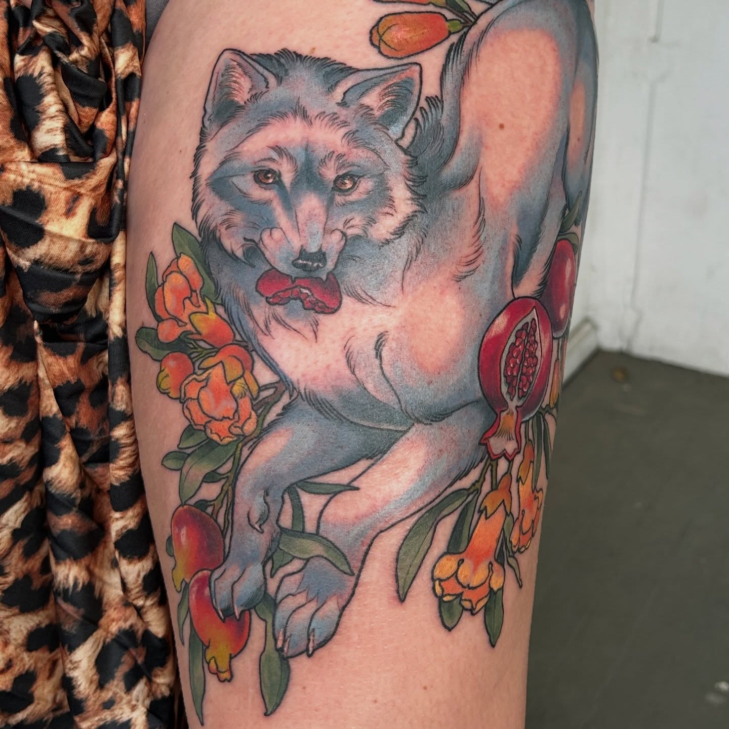 Wolf with flowers realism tattoo on the thigh by Anna Sylvan Tattoos