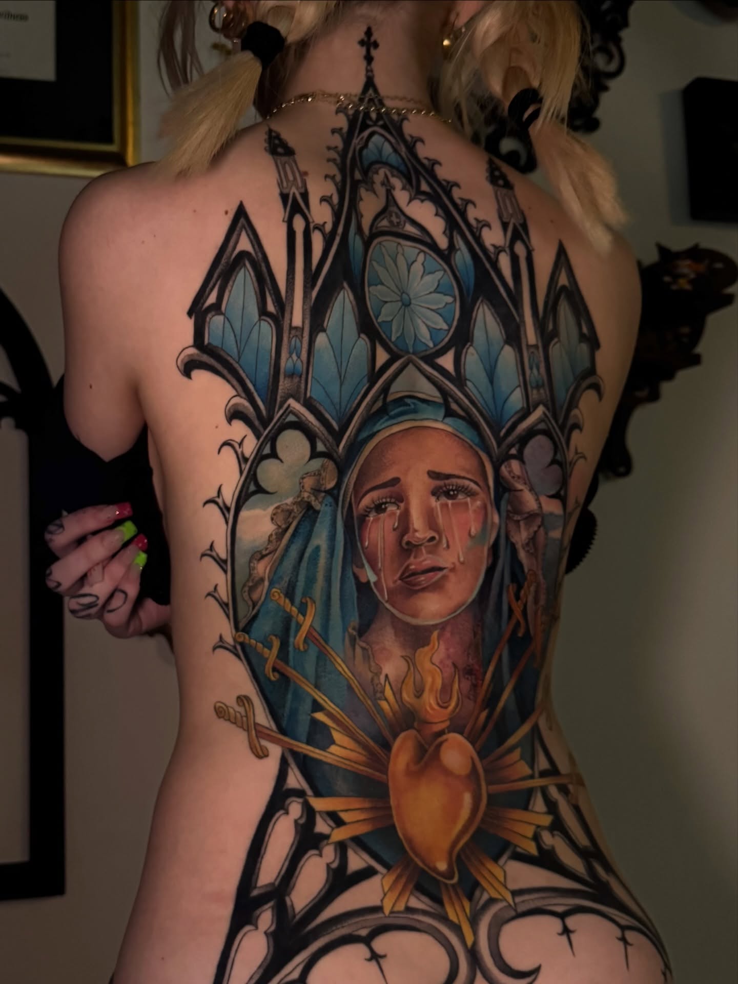 Religious figure with heart illustrative tattoo on the back by Mags🗡️