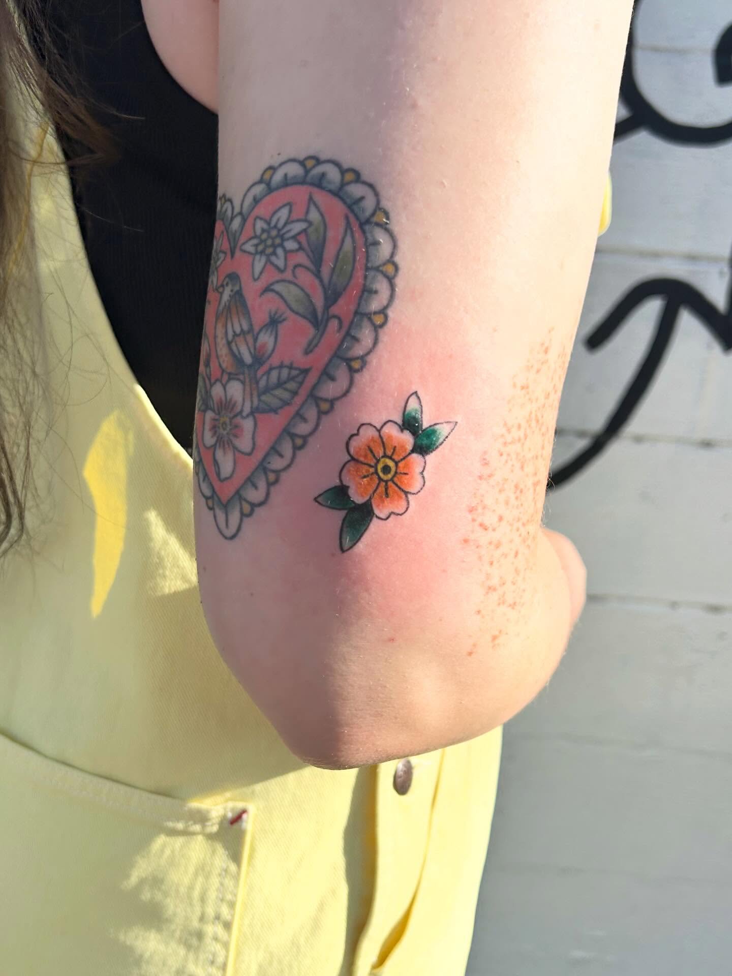 Heart with floral patterns American traditional tattoo on the forearm by Miss Katie