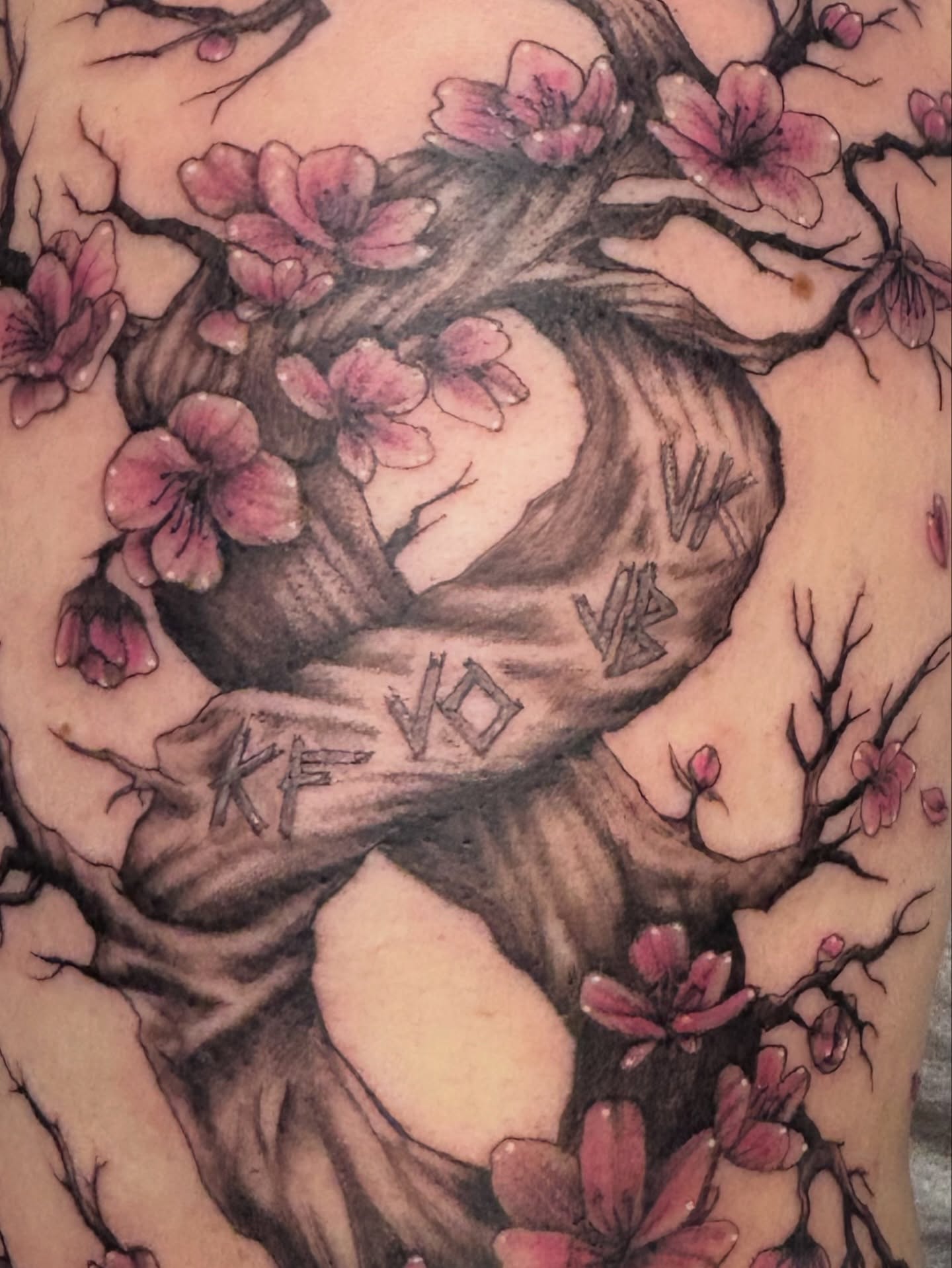 Cherry blossoms and tree trunk black and grey tattoo on the torso by Terik Whittaker