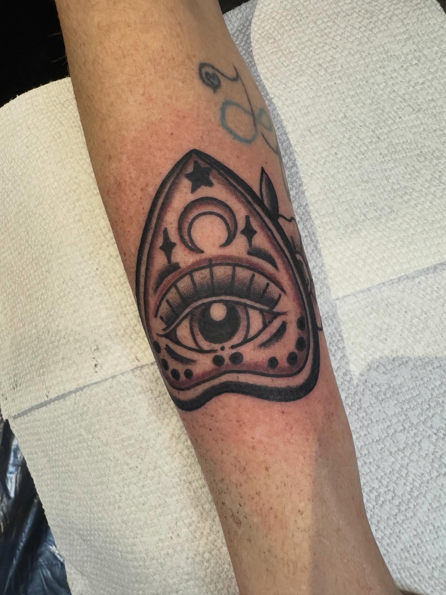 Eye American traditional tattoo on the forearm by Ethan Bennett