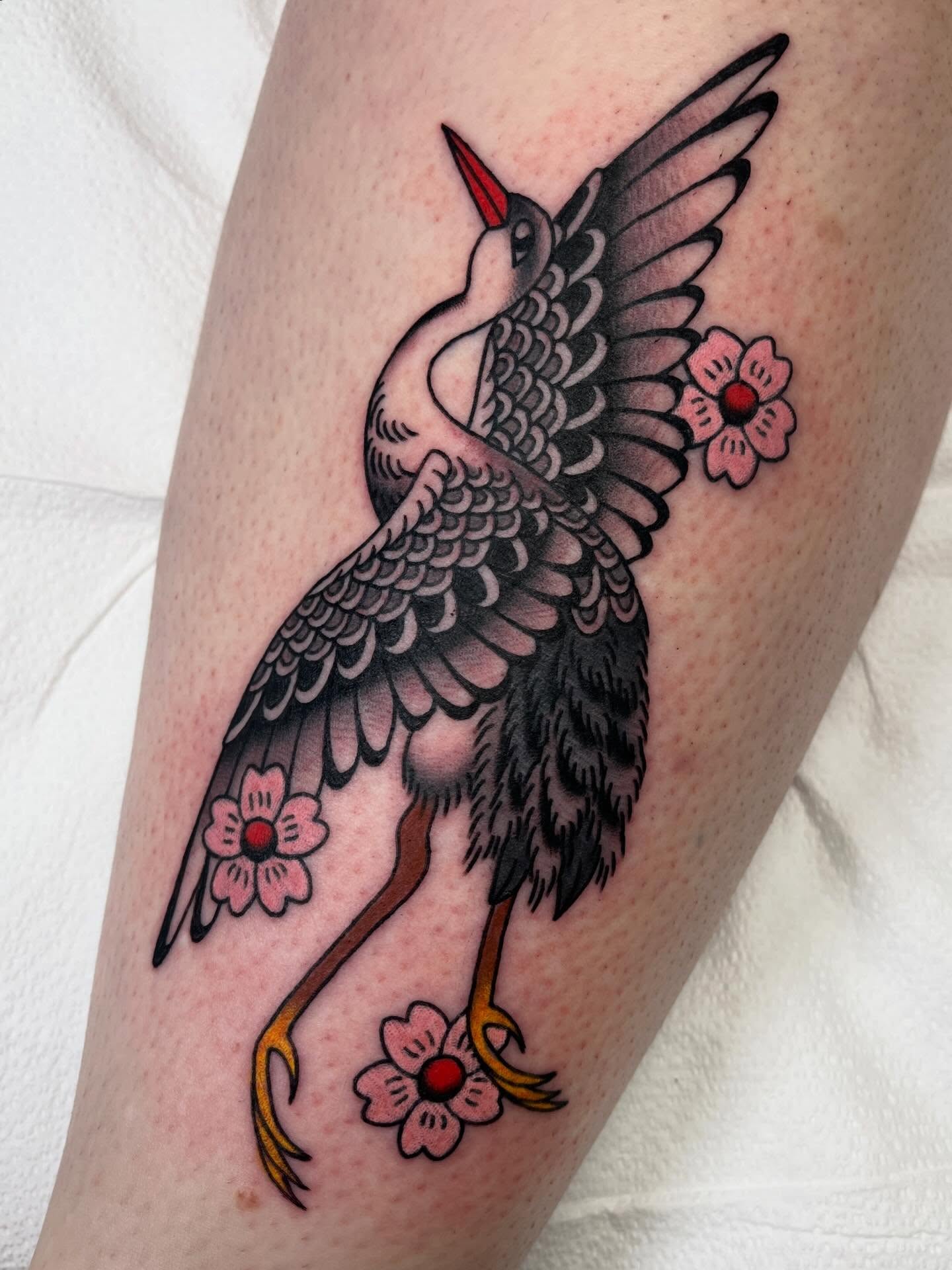 Bird with flowers American traditional tattoo on the thigh by 🌞all Bodies Welcome🌞