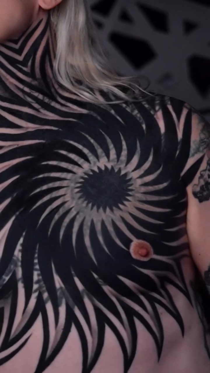 Geometric spiral chest and neck tattoo tribal tattoo on the torso by Ilya Cascad Kandaurov