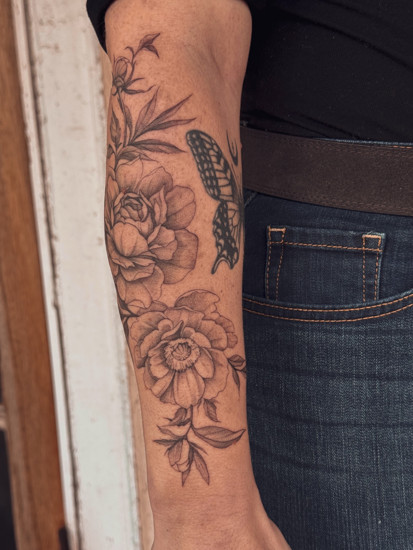 Flowers and butterfly realism tattoo on the forearm by Floral
