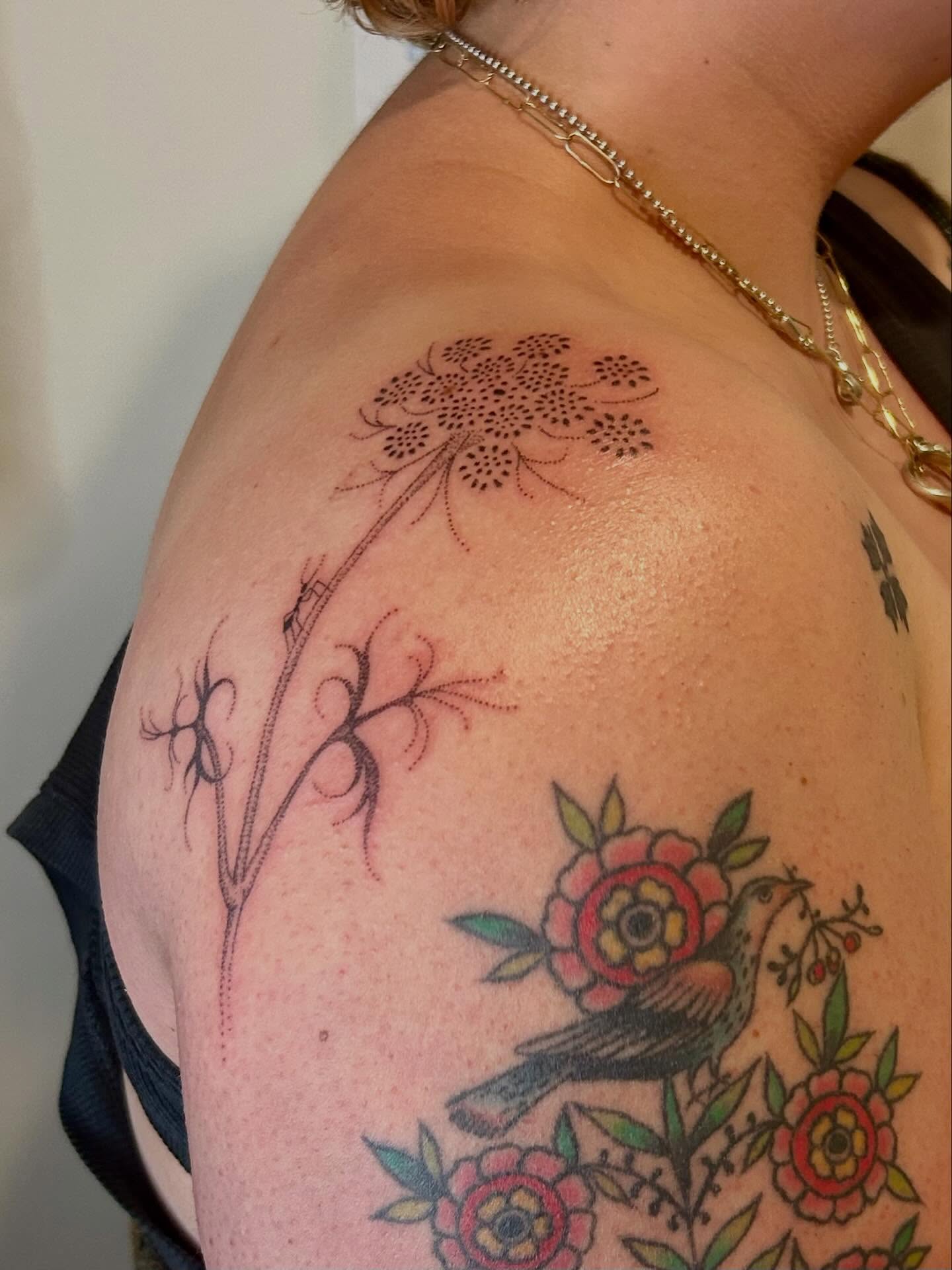 Bird and floral bouquet American traditional tattoo on the shoulder by Nicolette