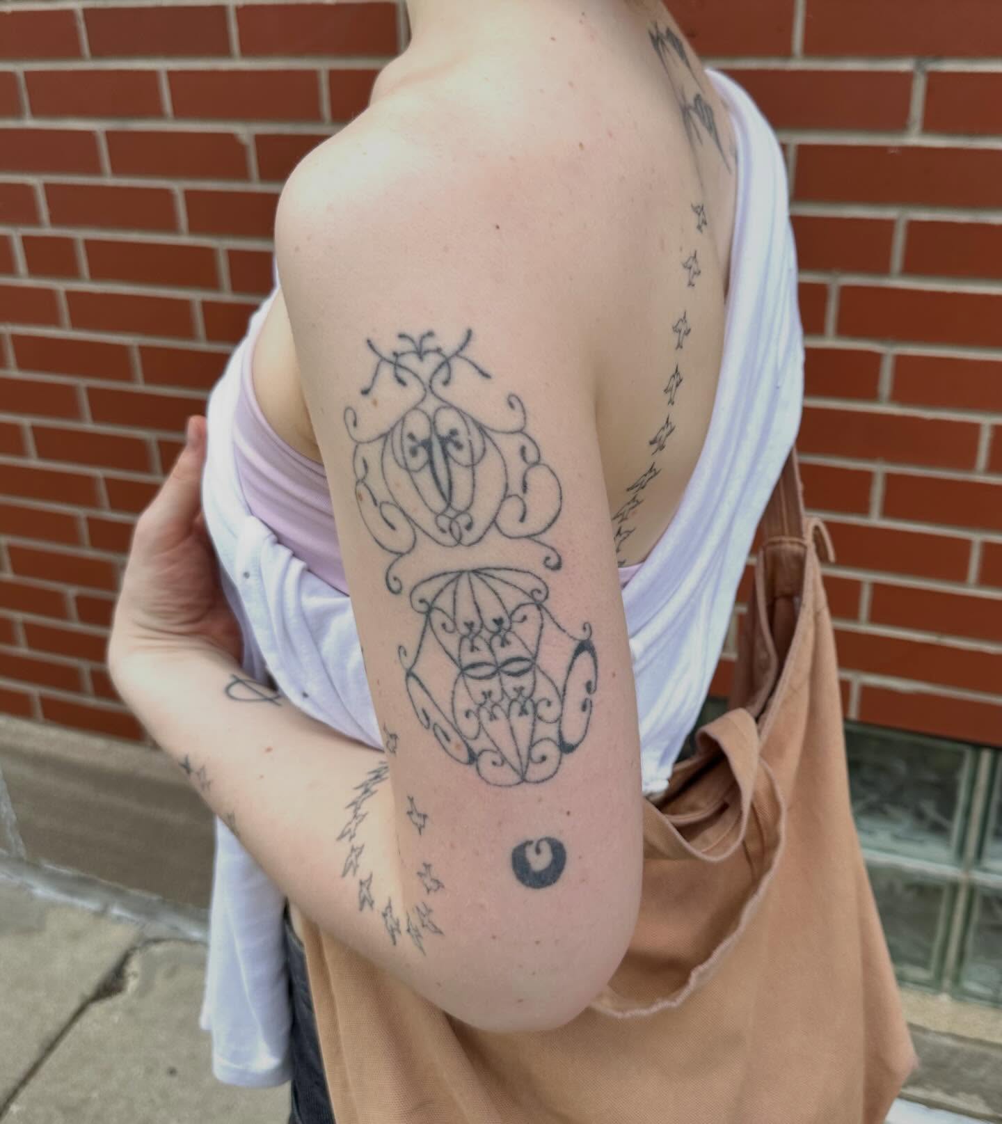 Abstract faces fine line tattoo on the forearm by kate