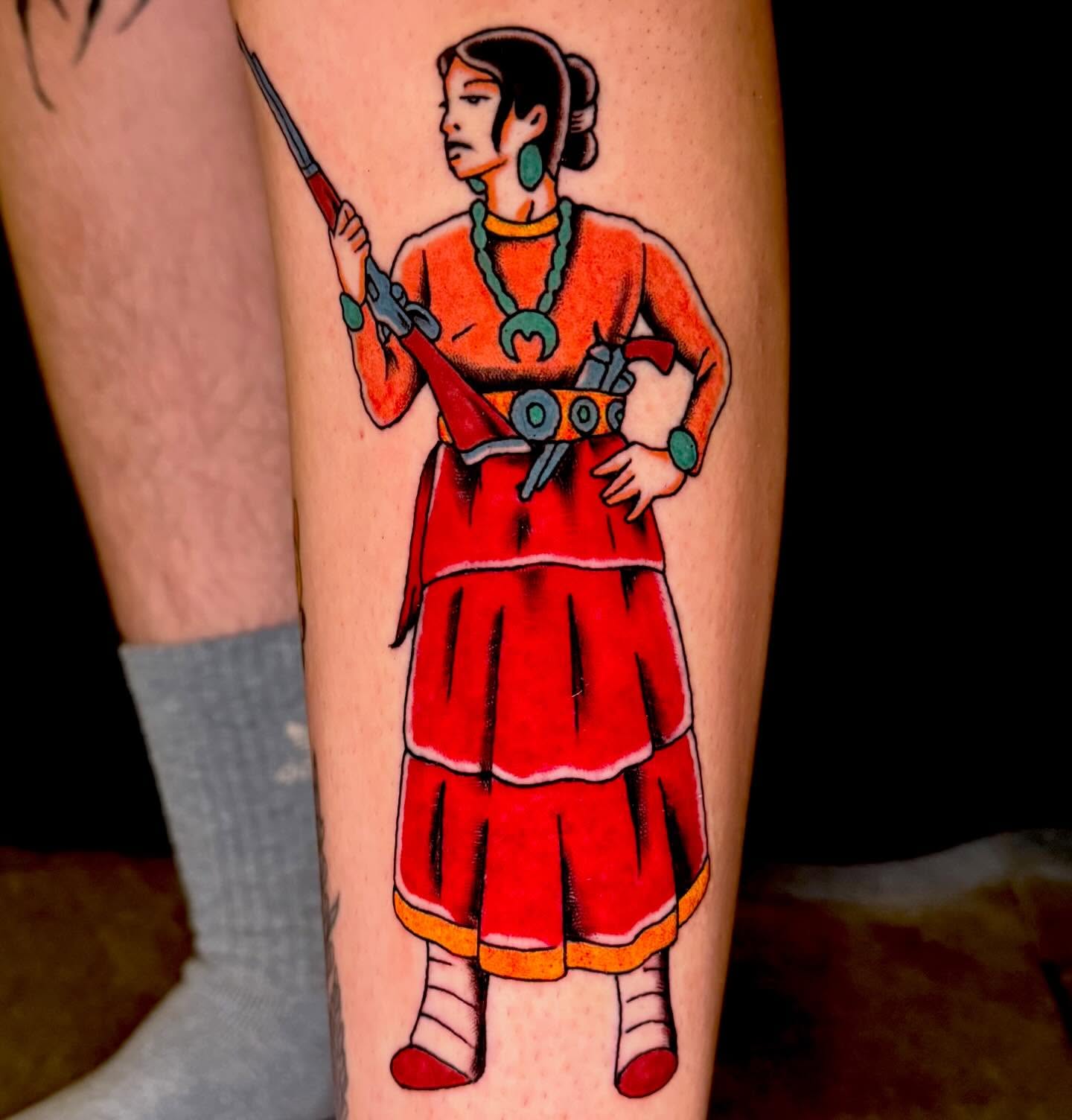 Woman with rifle American traditional tattoo on the forearm by Henry Bubula, Minneapolis, Minnesota