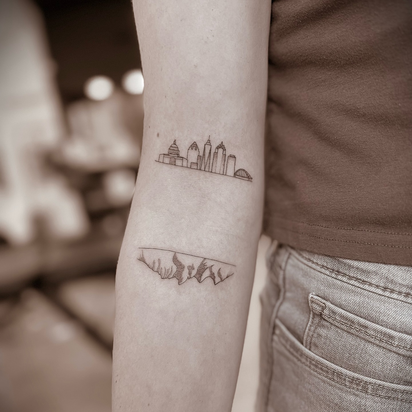 Cityscape geometric tattoo on the forearm by Chanel Picquelle, Nashville, Tennessee