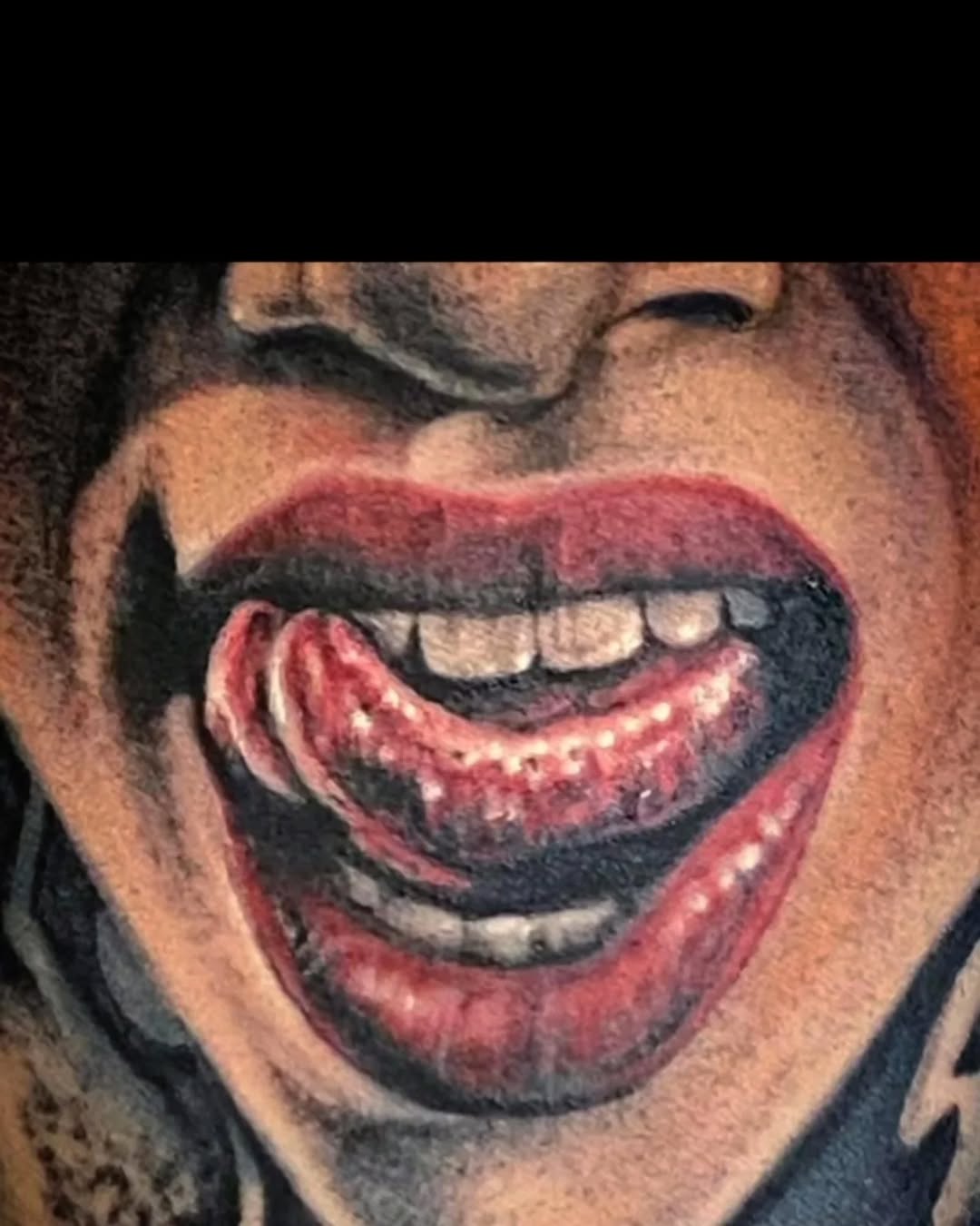 Mouth with tongue out realism tattoo on the head by Watson Gutkowski