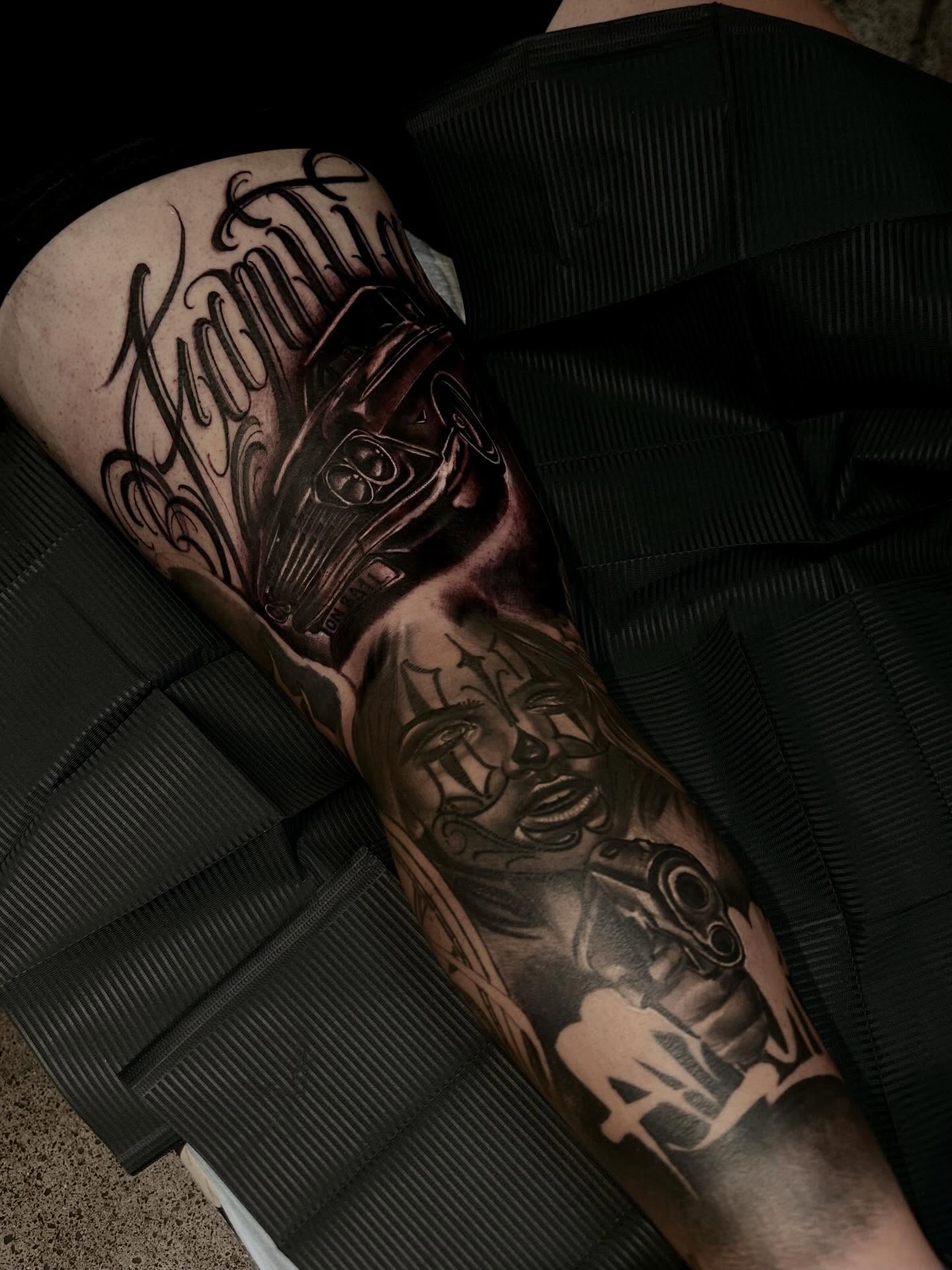 Mask and script tribal tattoo on the forearm by Italo Holie