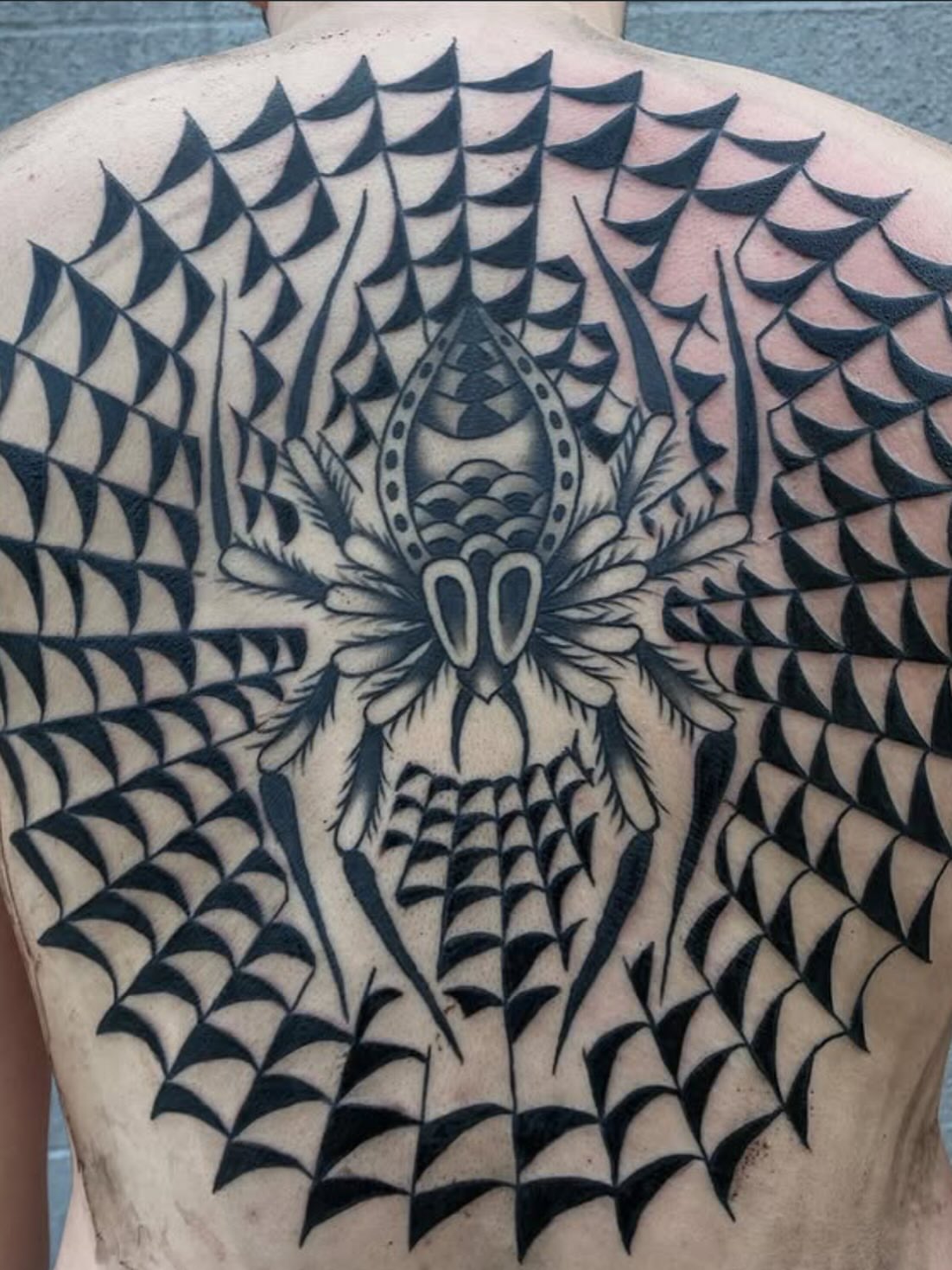 Geometric spider geometric tattoo on the back by Jacqui Rose