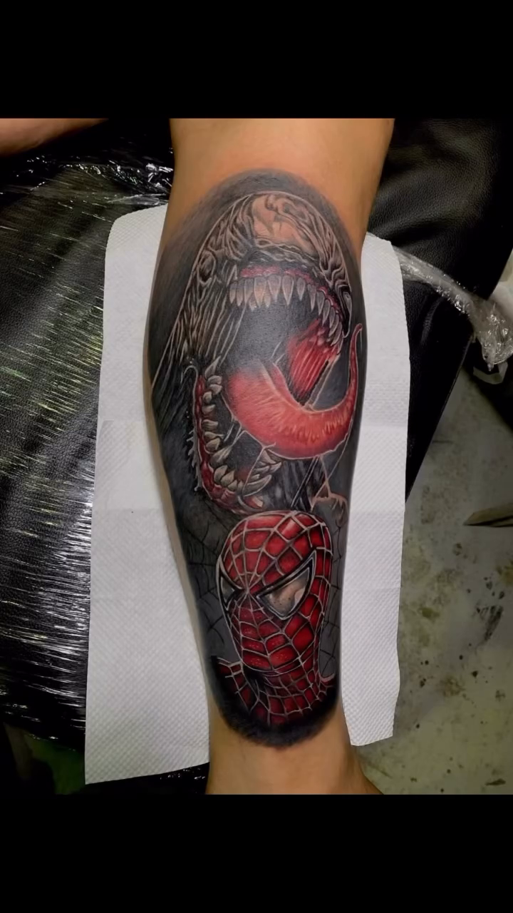 Venom and Spider-Man characters realism tattoo on the upper arm by Gerd thINK_TATTOO