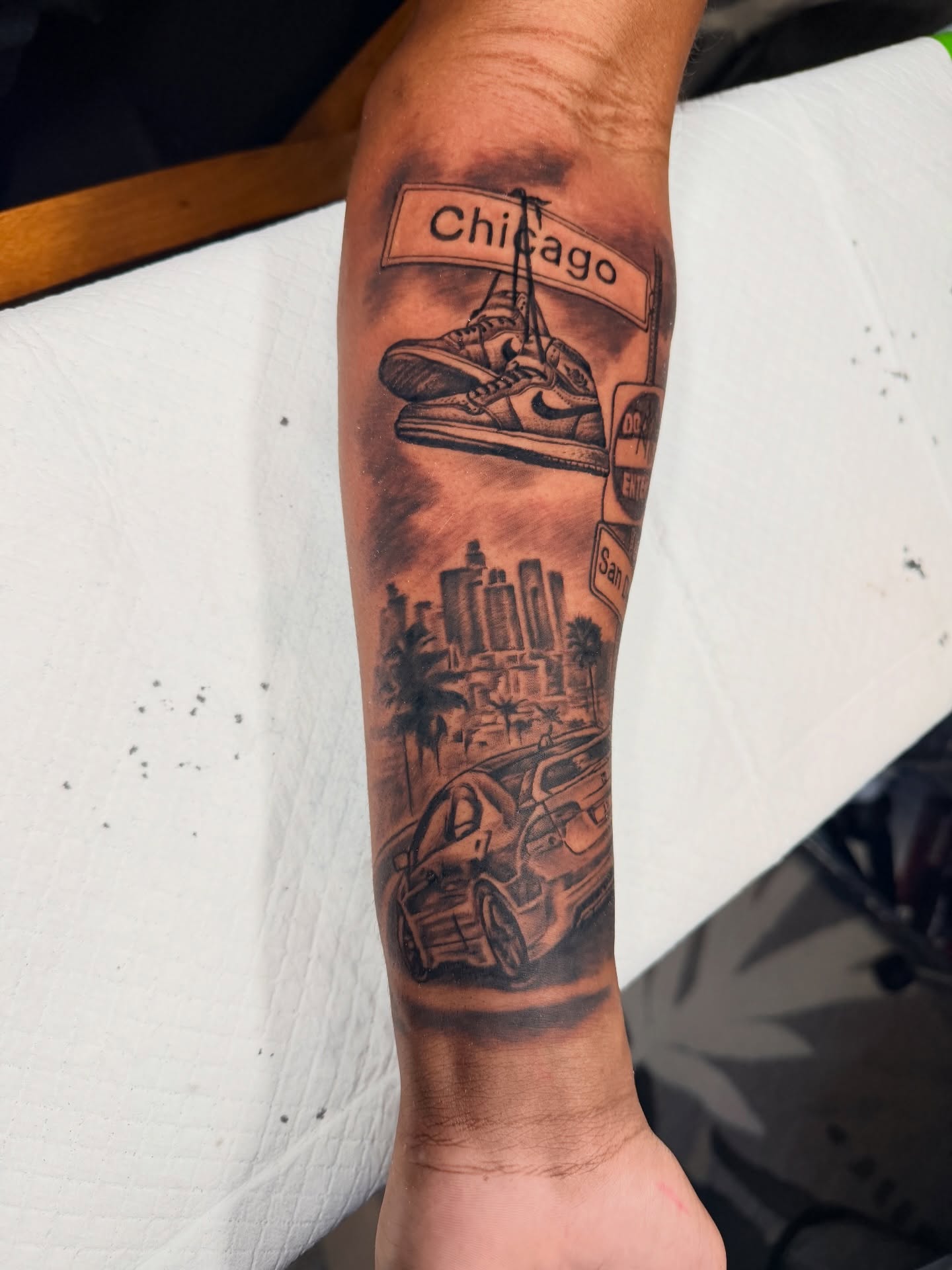 Chicago skyline and car realism tattoo on the forearm by John Ayson, Murrieta, California