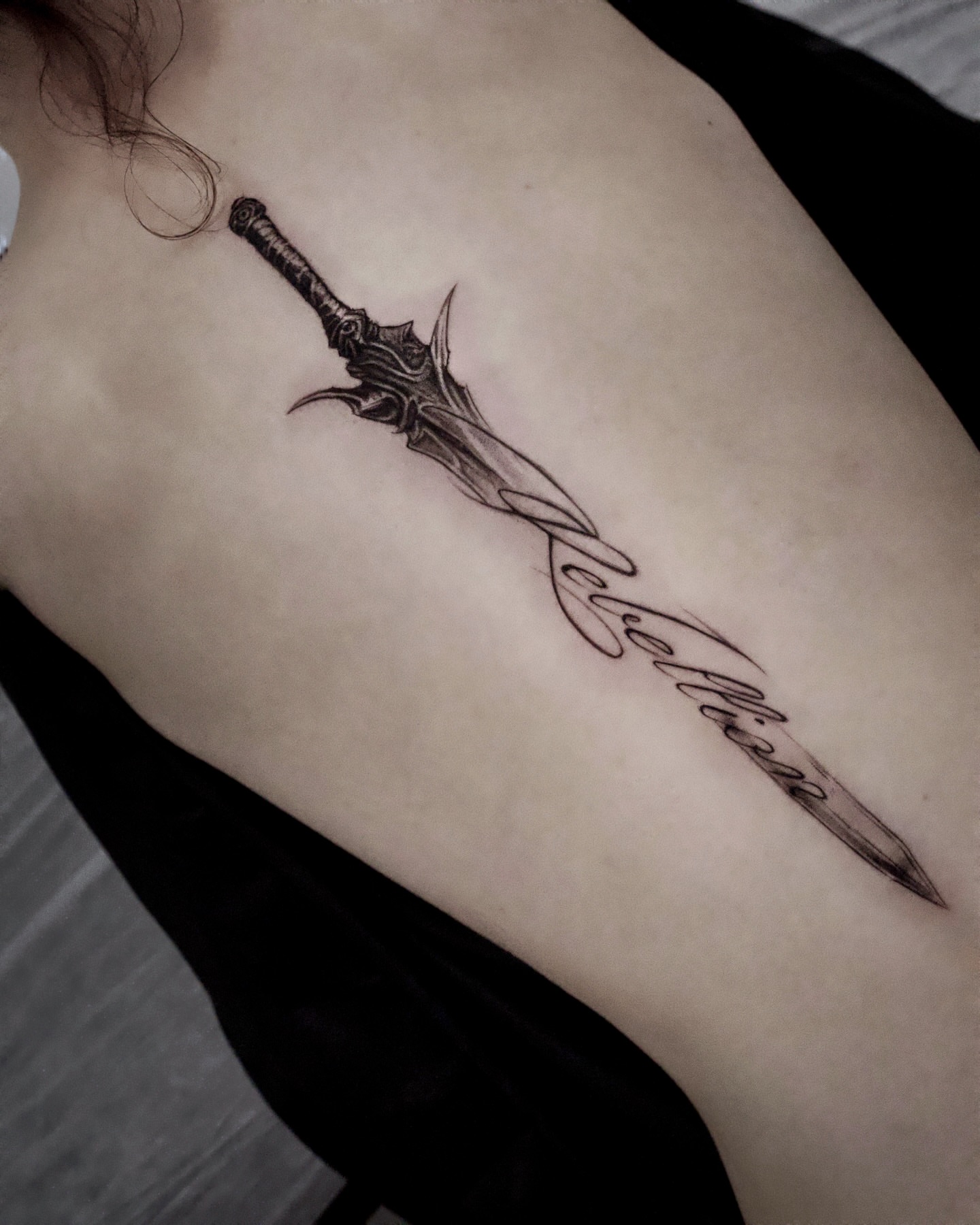 Sword black and grey tattoo on the ribs by Gun