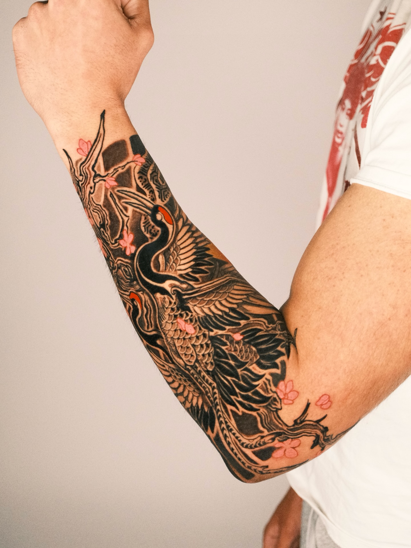 Cranes and cherry blossoms japanese irezumi tattoo on the forearm by Kubo