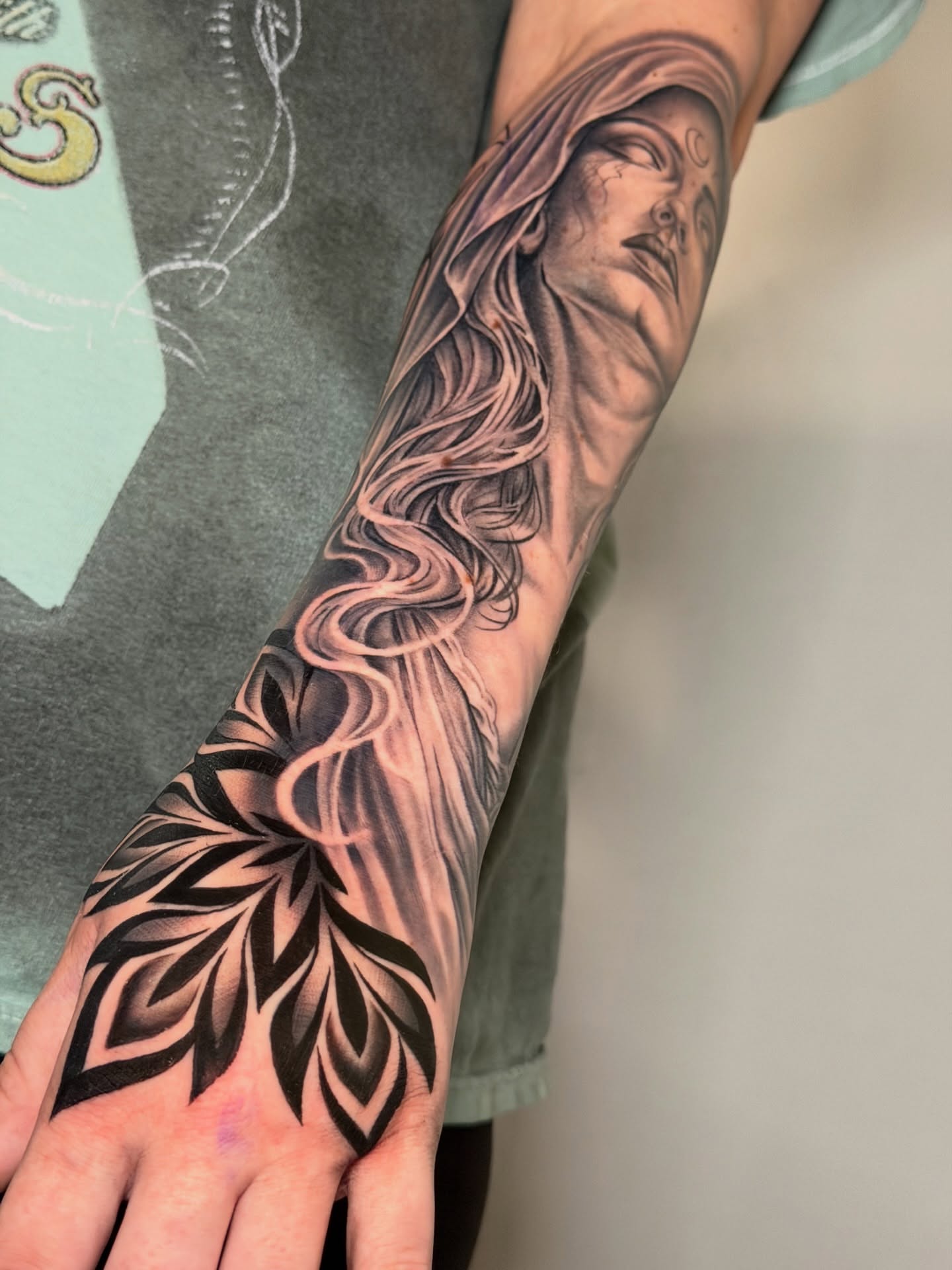 Woman's face with flowing hair realism tattoo on the forearm by Ray Paponetti - Tattoo Artist Delray Beach