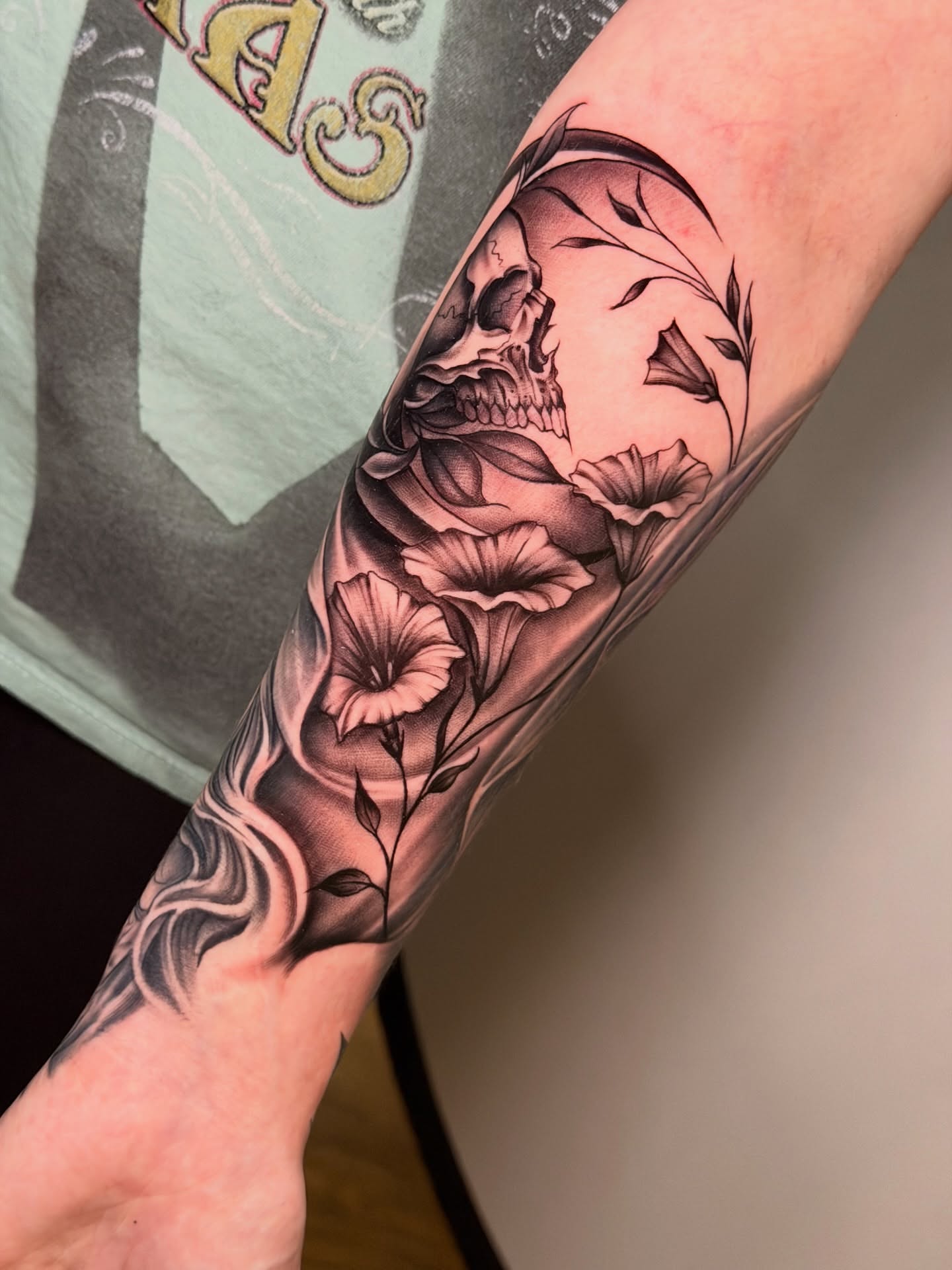 Skull and flowers realism tattoo on the forearm by Ray Paponetti - Tattoo Artist Delray Beach