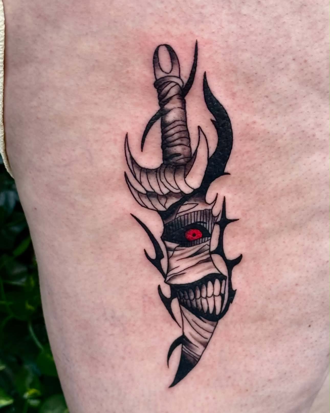 Mummy head with horns dark realism tattoo on the thigh by Sabrina