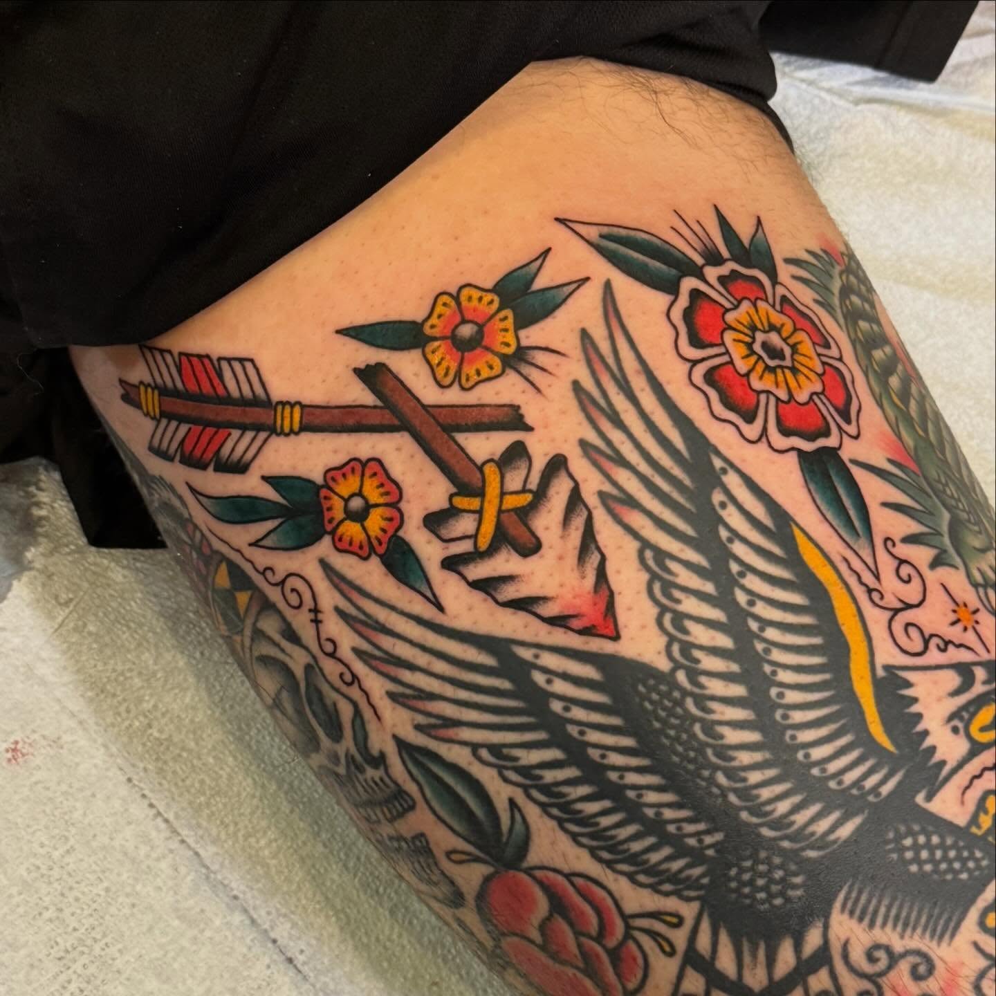 Eagle and flowers American traditional tattoo on the thigh by Justin Rakowski