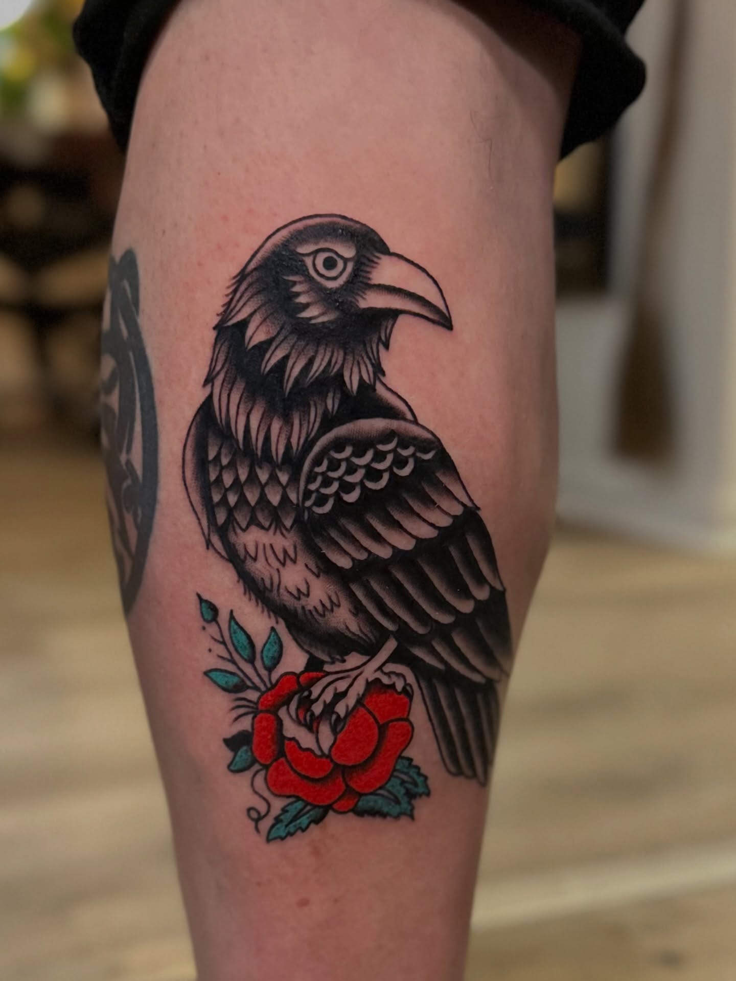 Crow and rose American traditional tattoo on the thigh by Tyyler Santor (Tattoo Artist), Somerville, Massachusetts