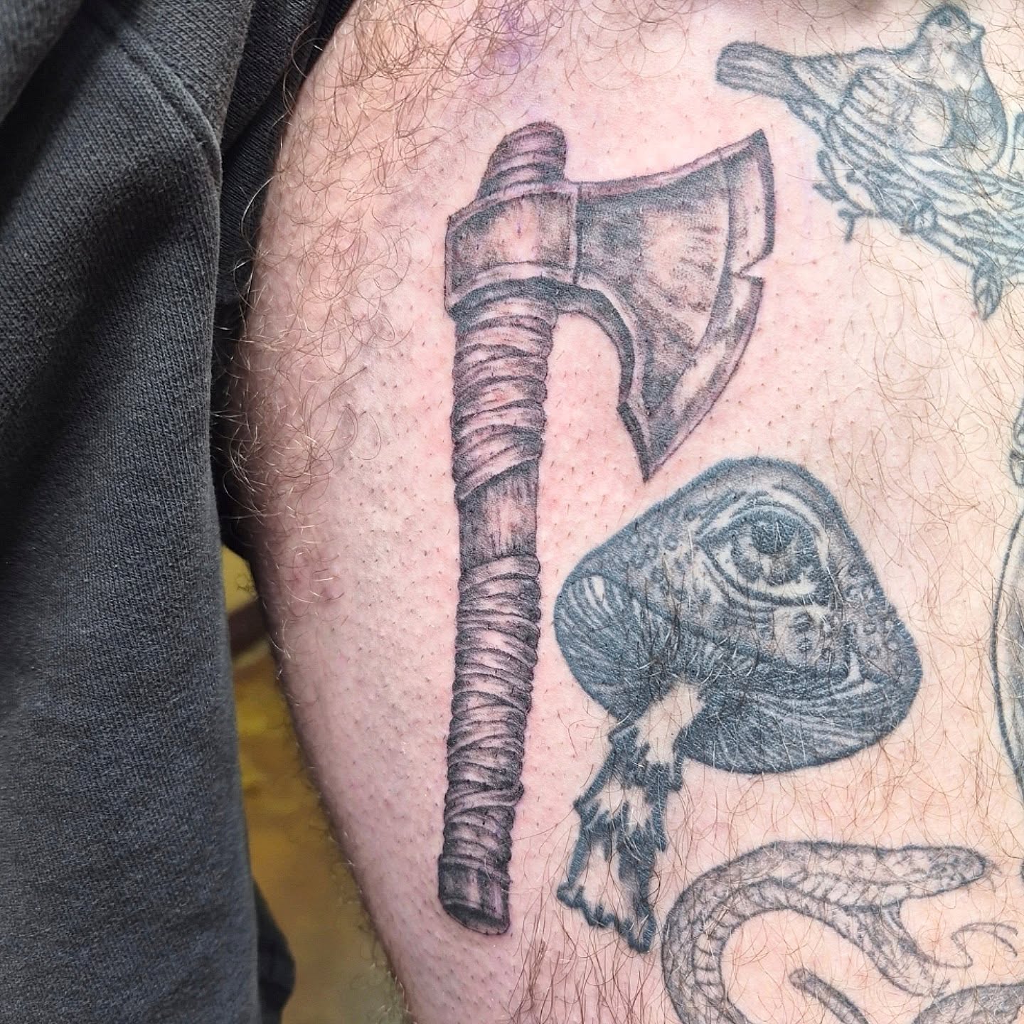 Ax and eye realism tattoo on the thigh by Chris Bell