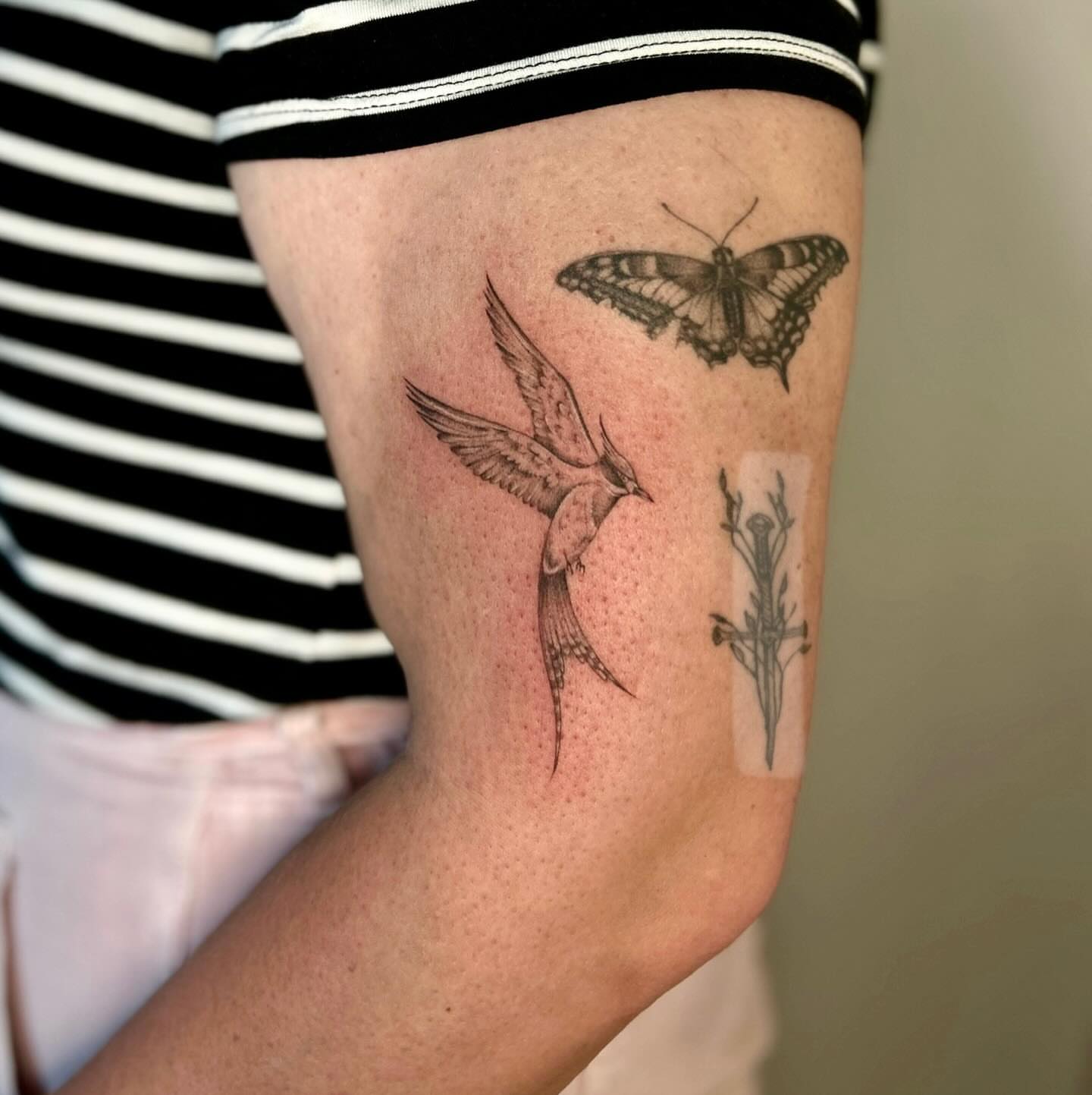 Bird, butterfly, flower realism tattoo on the forearm by L i v π Tattoo Artist. AMITY TATTOO