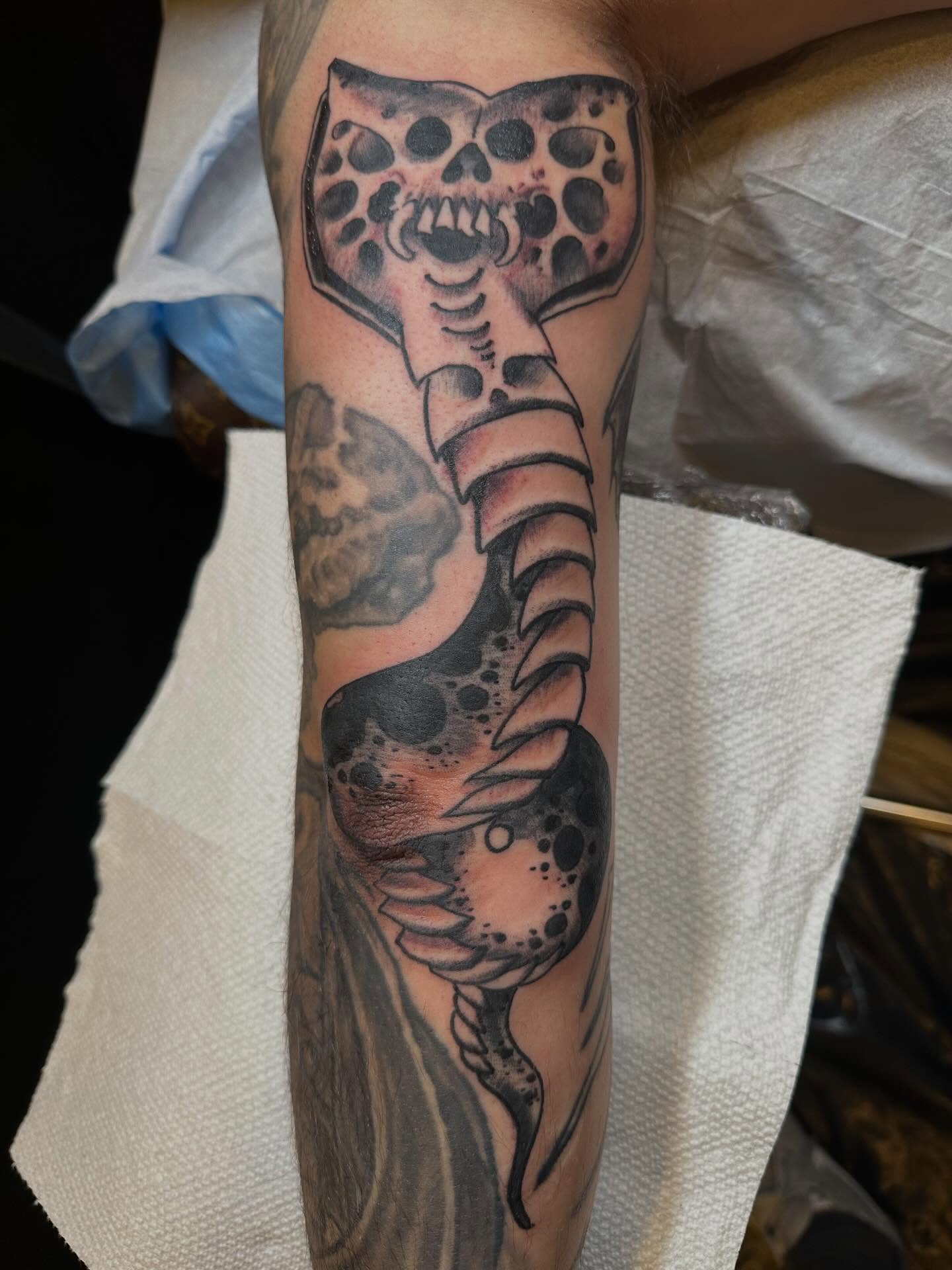 Mace with skulls black and grey tattoo on the forearm by Joey Knuckles