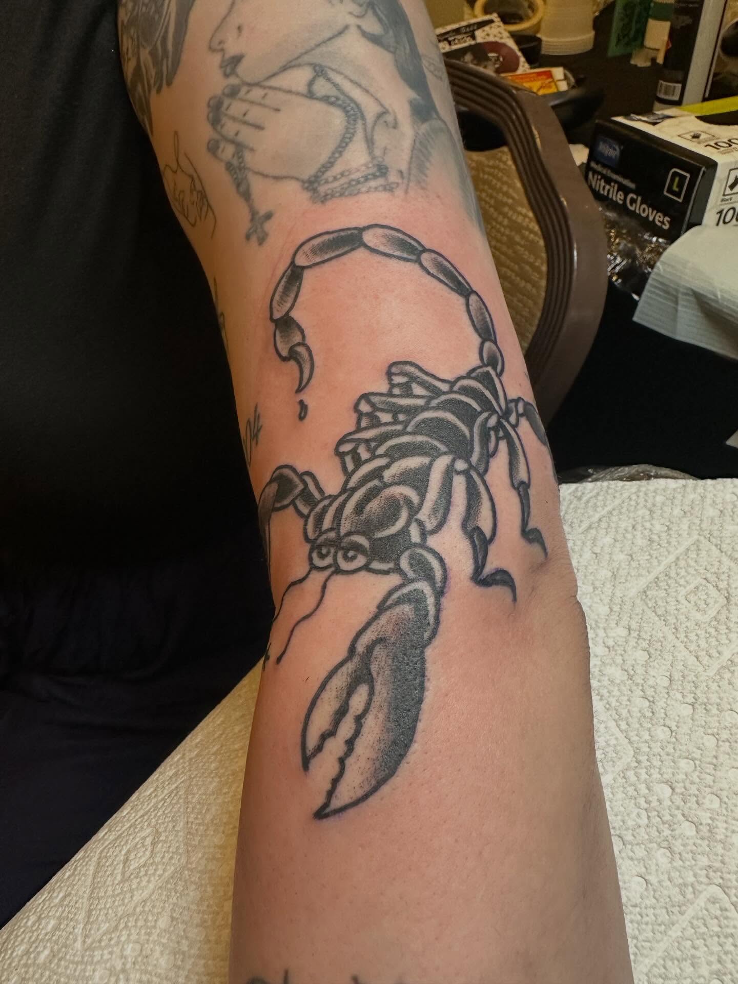 Scorpion black and grey tattoo on the forearm by Joey Knuckles