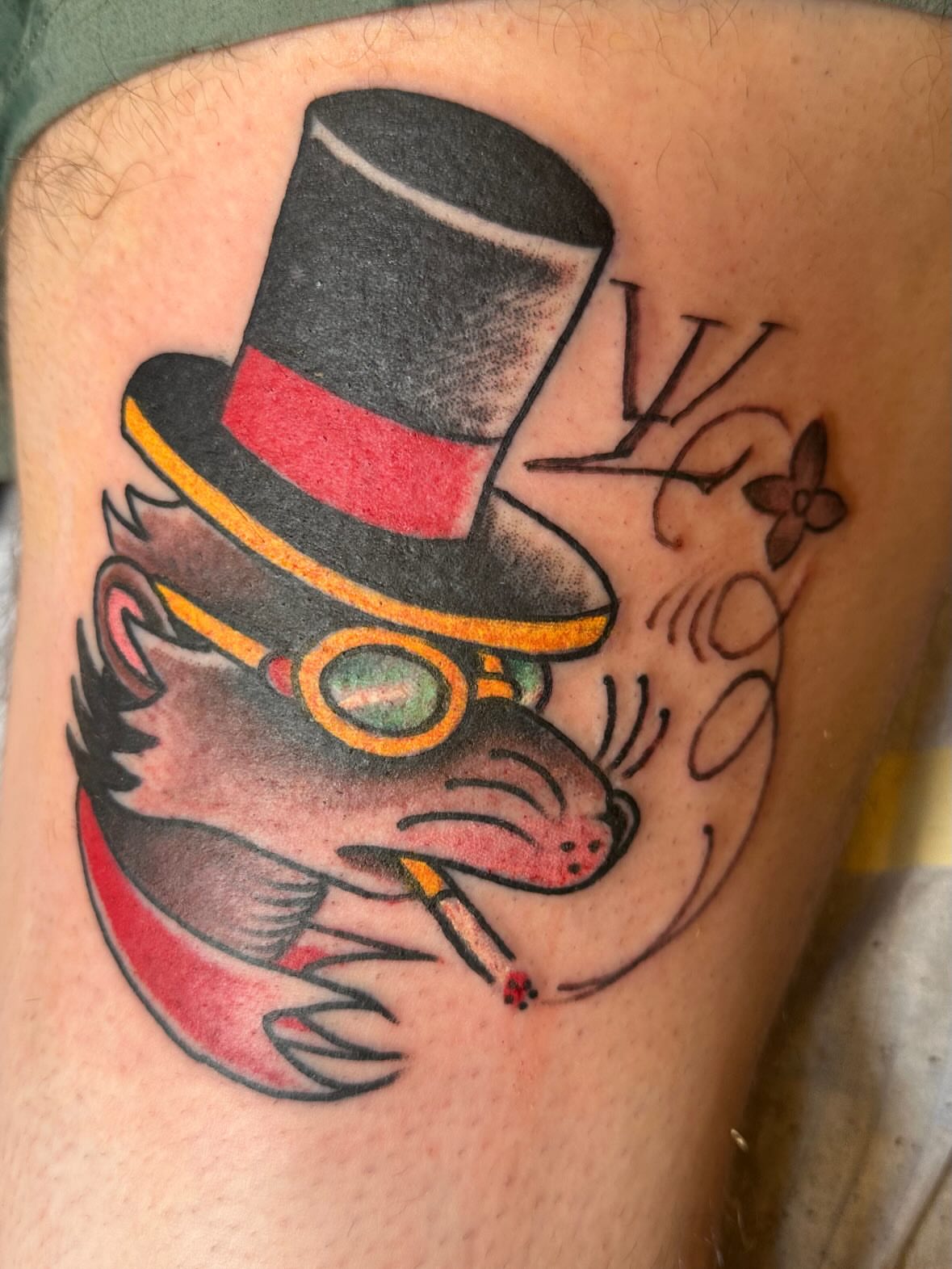 Cat wearing top hat American traditional tattoo on the thigh by Joey Knuckles