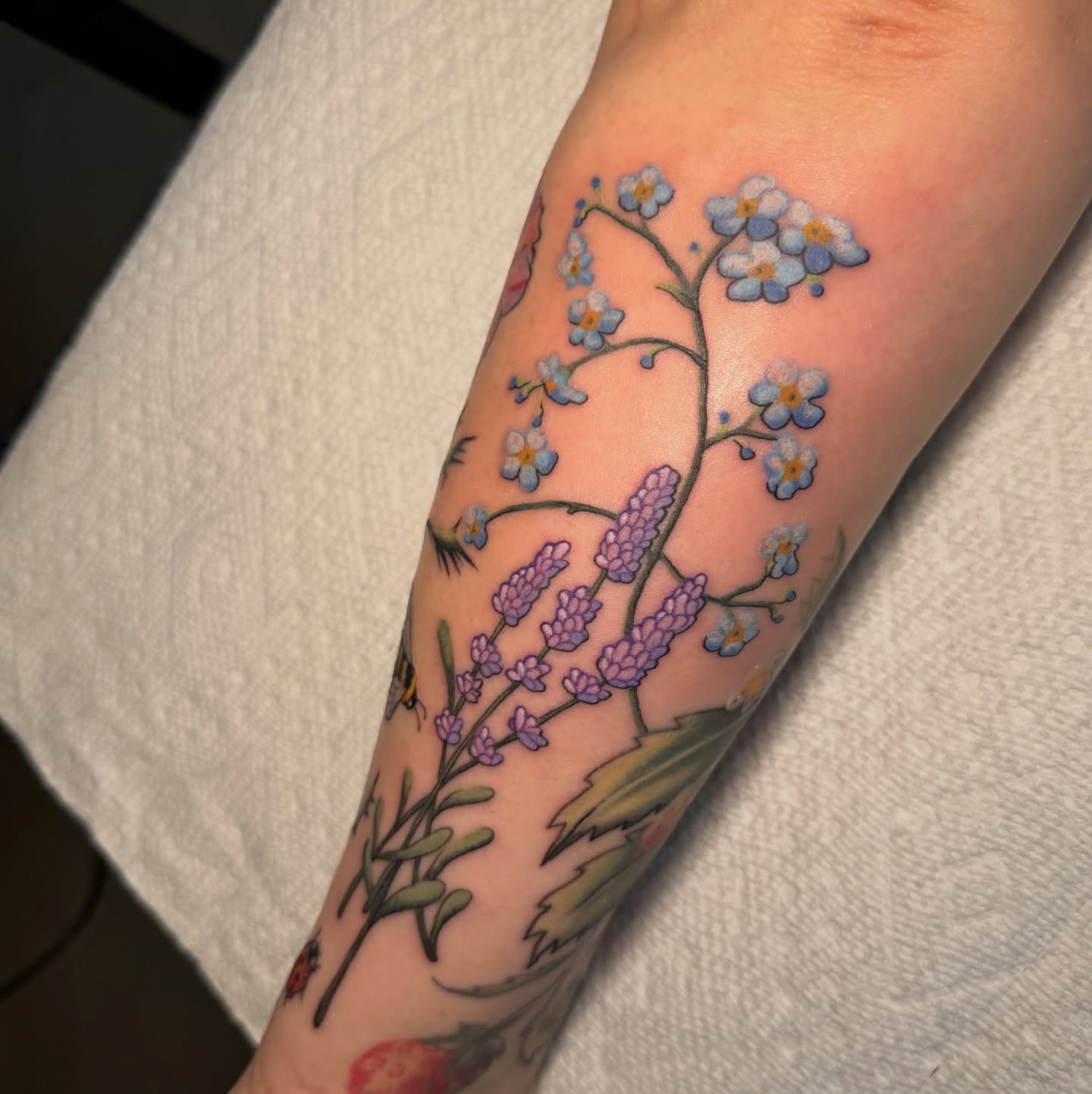 Floral arrangement realism tattoo on the forearm by Lyndze Masters