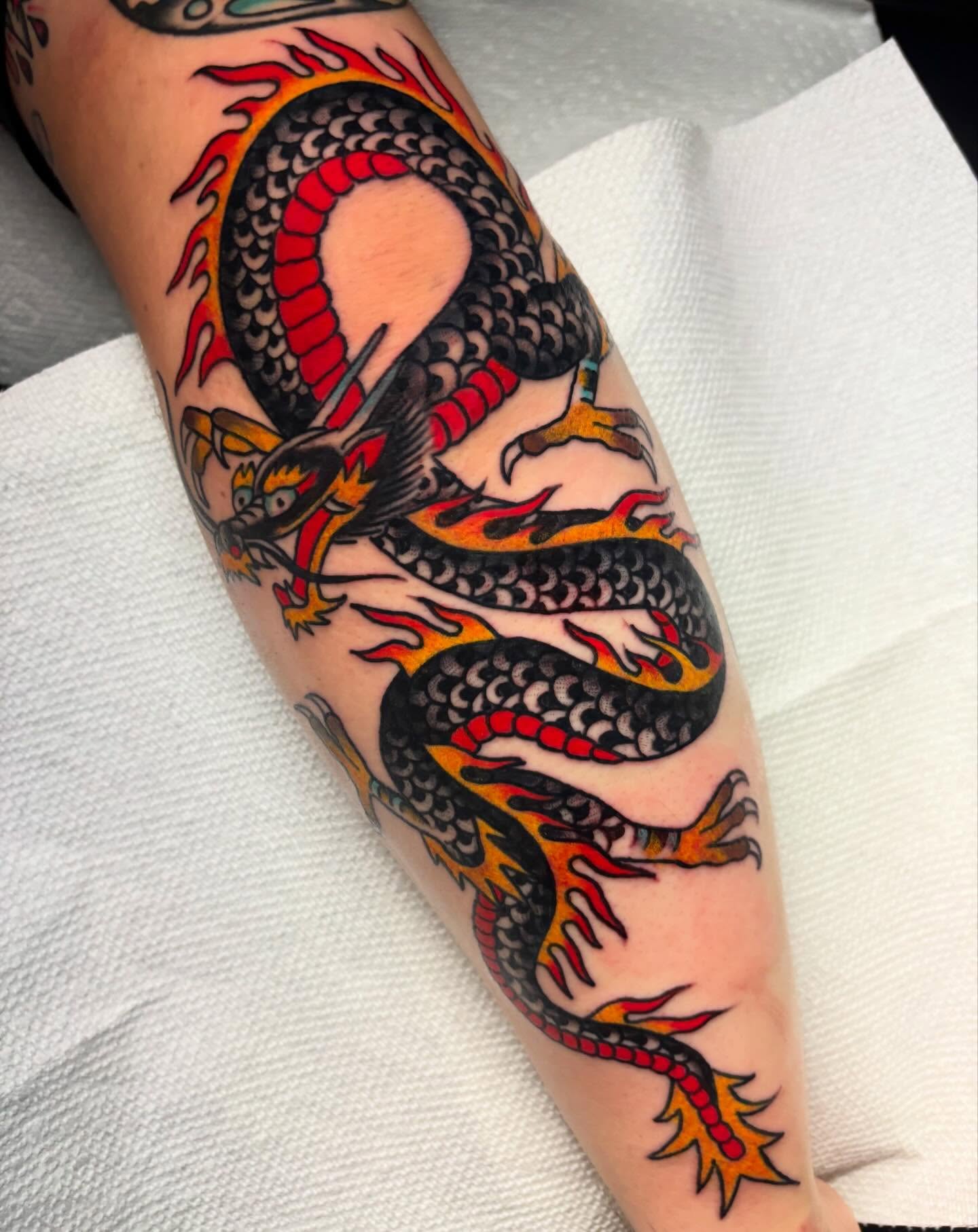 Dragon American traditional tattoo on the forearm by Chris Dufresne