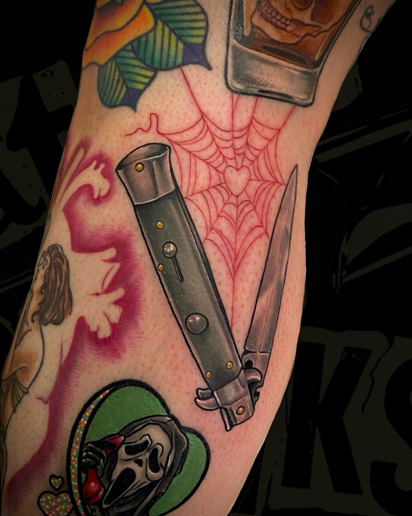 Knife and spiderweb American traditional tattoo on the forearm by Teddi Garson
