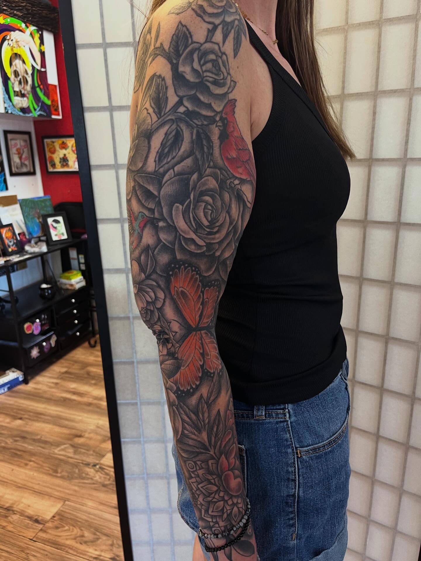 Roses and butterflies realism tattoo on the upper arm by Danielle Lorandeau