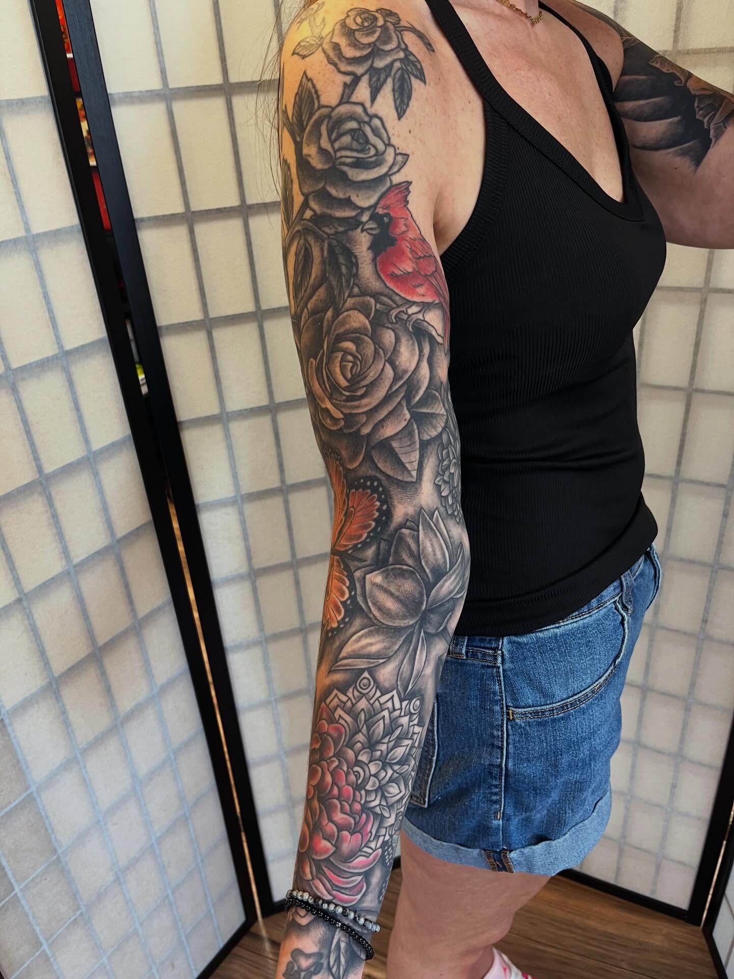Floral bouquet realism tattoo on the upper arm by Danielle Lorandeau