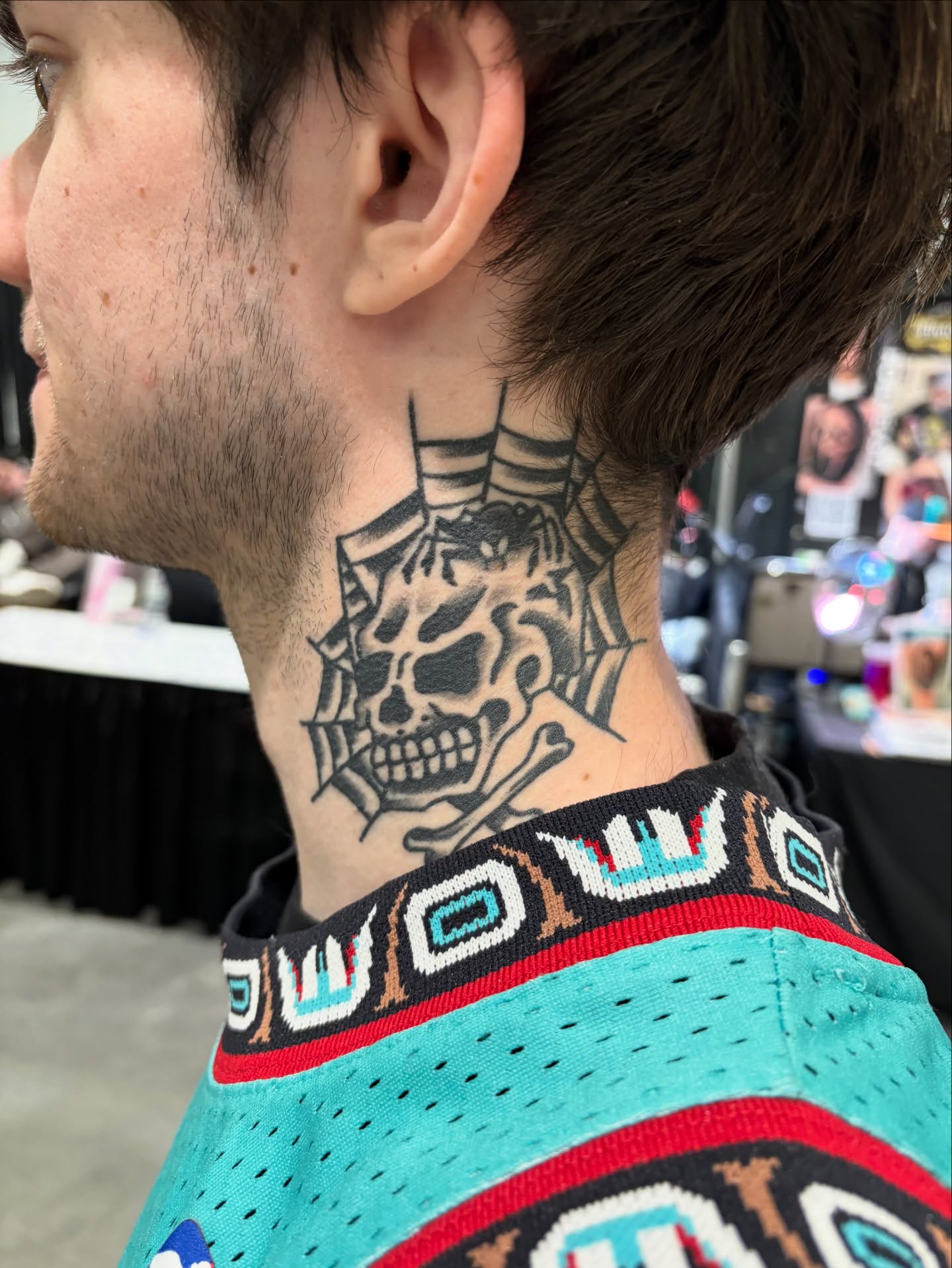 Skull and crossbones American traditional tattoo on the neck by Andrew Silva