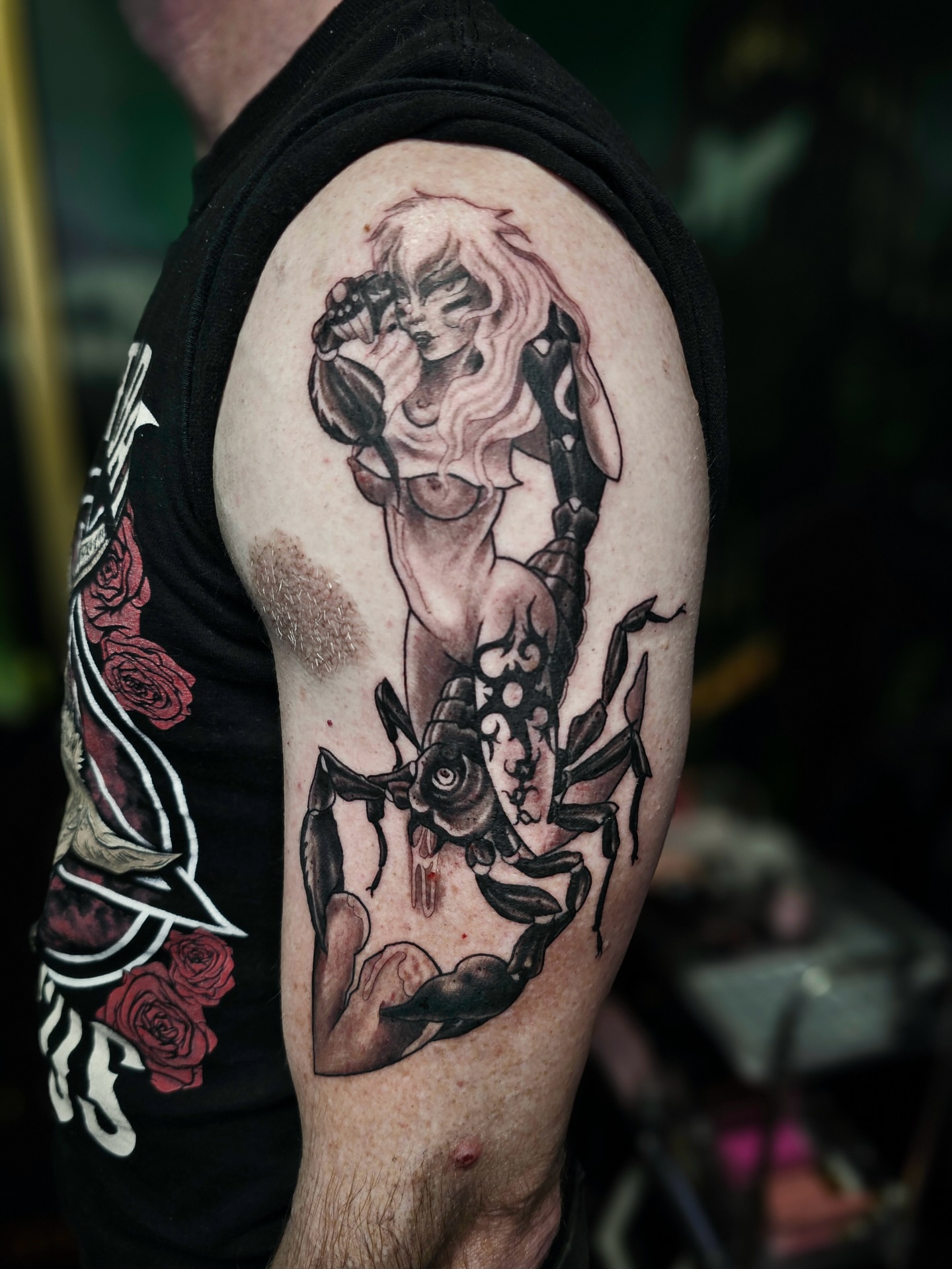 Scorpion and woman realism tattoo on the upper arm by Ella Trick