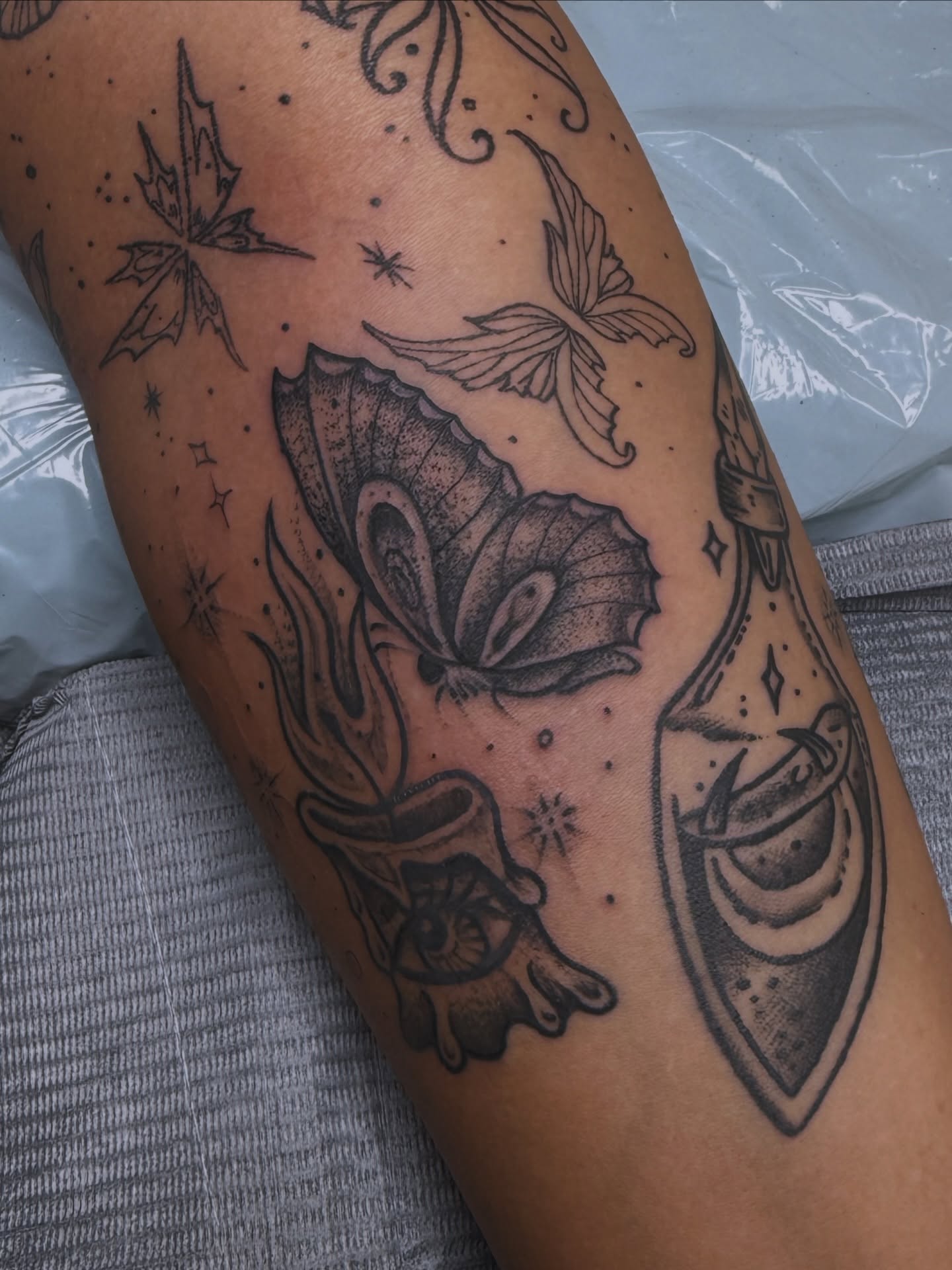 Butterfly and shield dotwork tattoo on the forearm by Ramón Silva