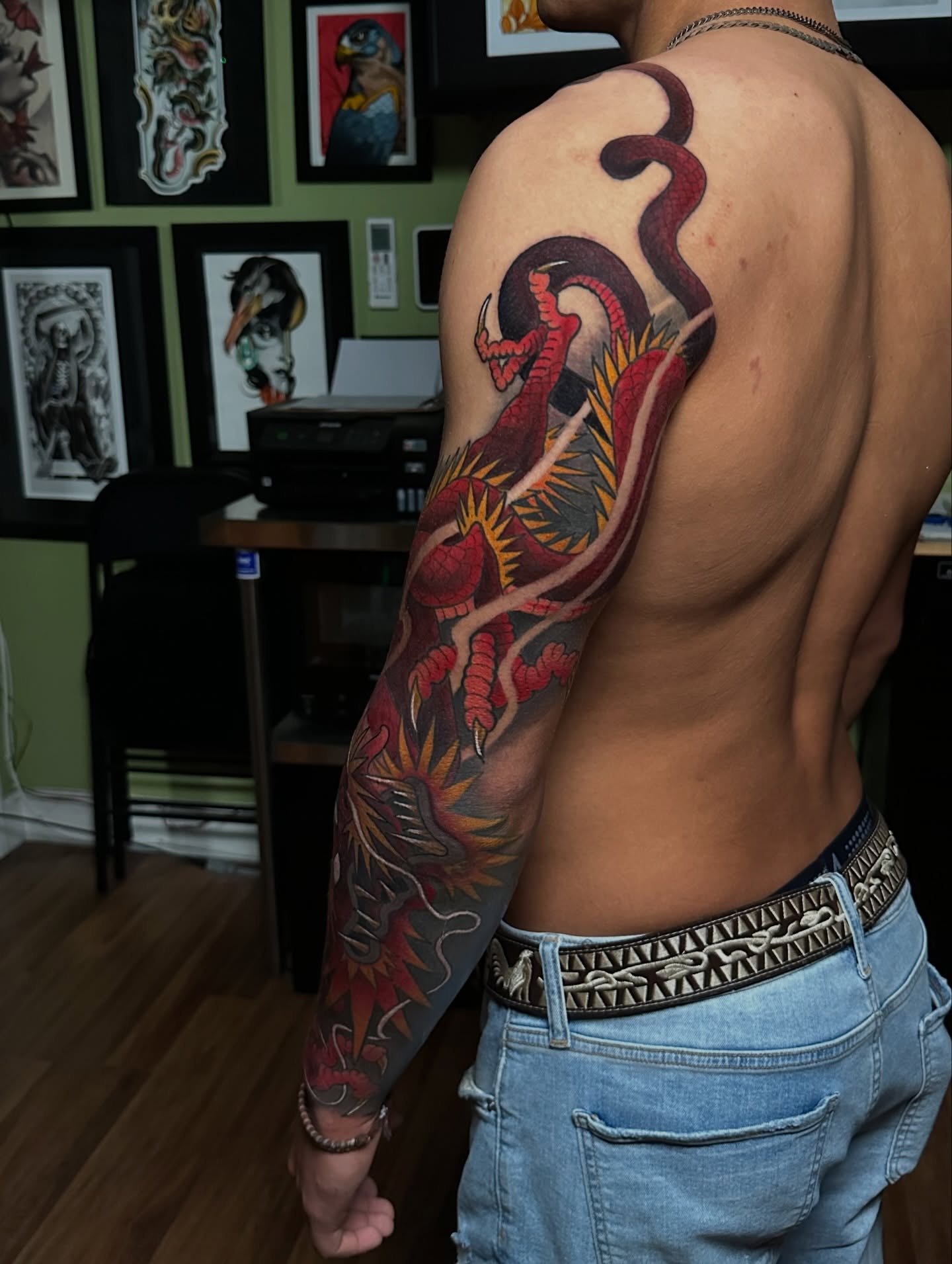 Dragon and flames American traditional tattoo on the upper arm by Trevor Burtz