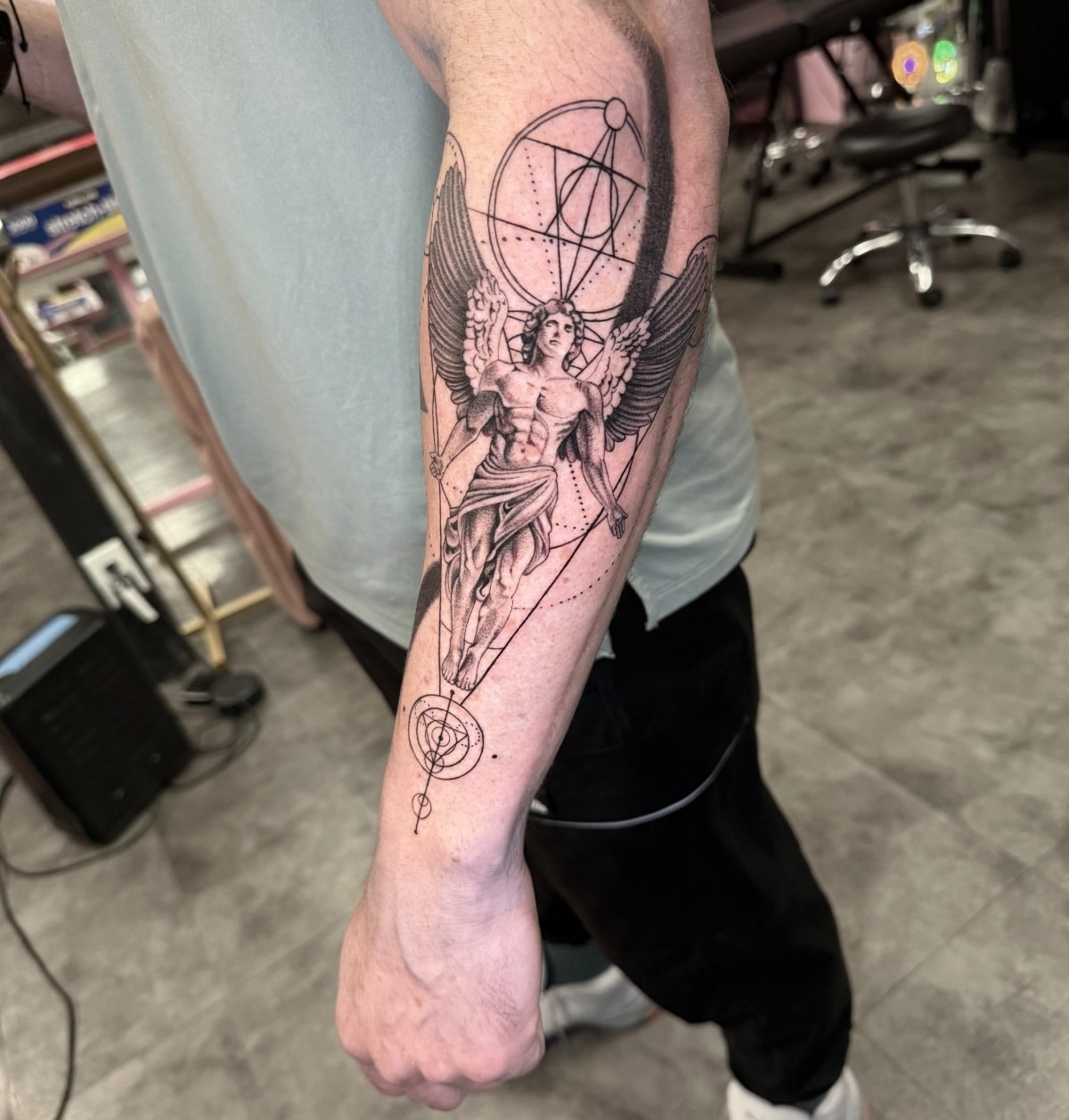 Statue with wings realism tattoo on the forearm by Tattoo Artist Vanessa