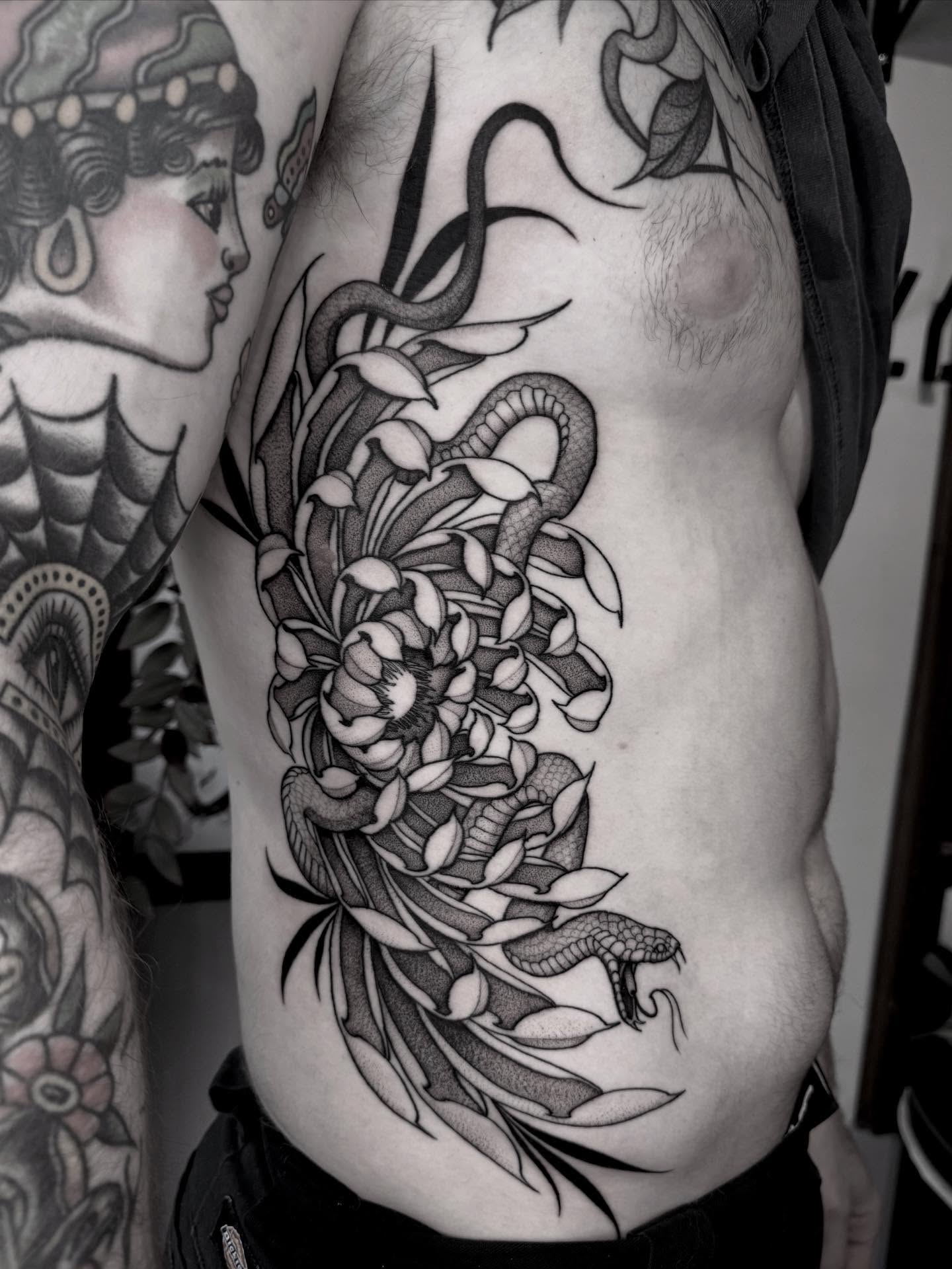 Snake and peony japanese irezumi tattoo on the ribs by Lauren Llerandi